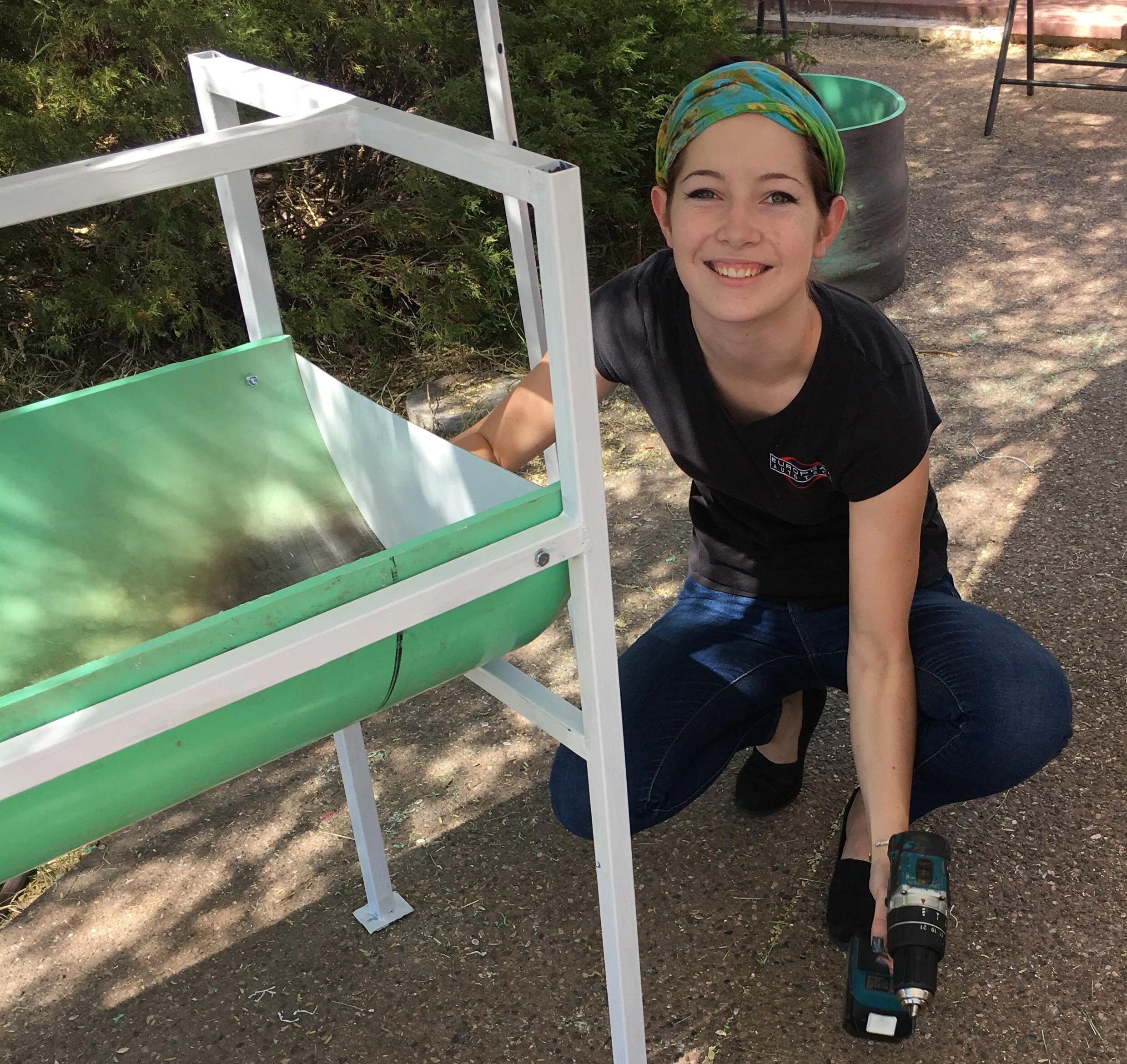 Our daughter fitting the trough caps in place on early donated stations.
