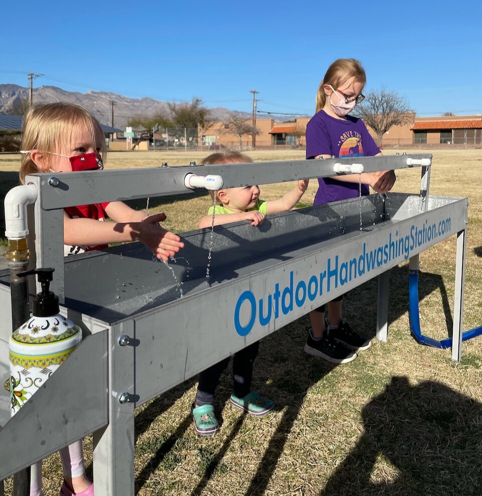 Students from preschool to elementary washing their hands in our original outdoor handwashing station.