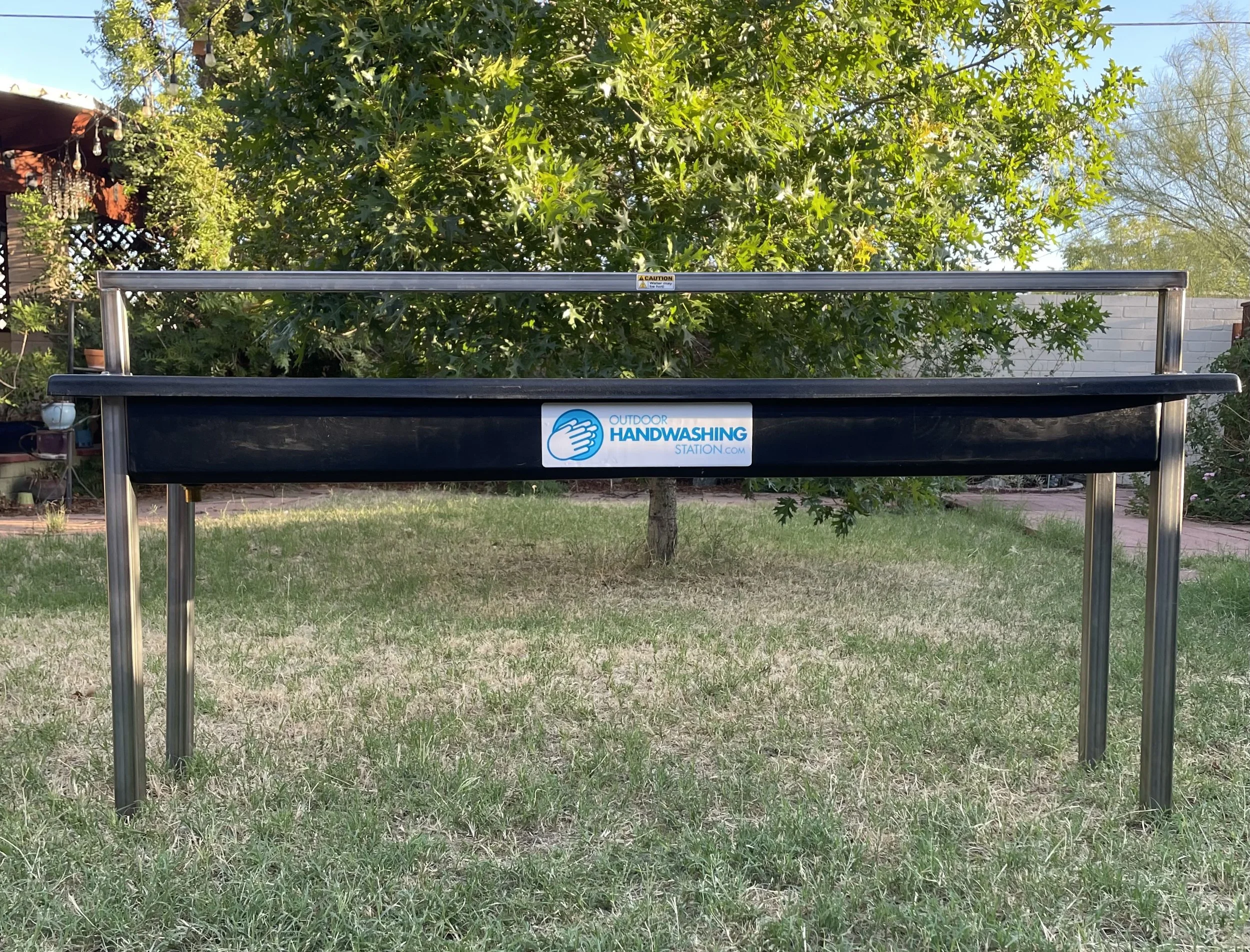 6 person outdoor handwashing station set up on a lawn in front of an oak tree