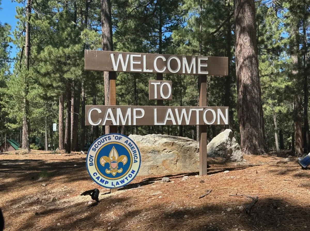 Wooden sign in the Ponderosa Pine forest reading Welcome to Camp Lawton.