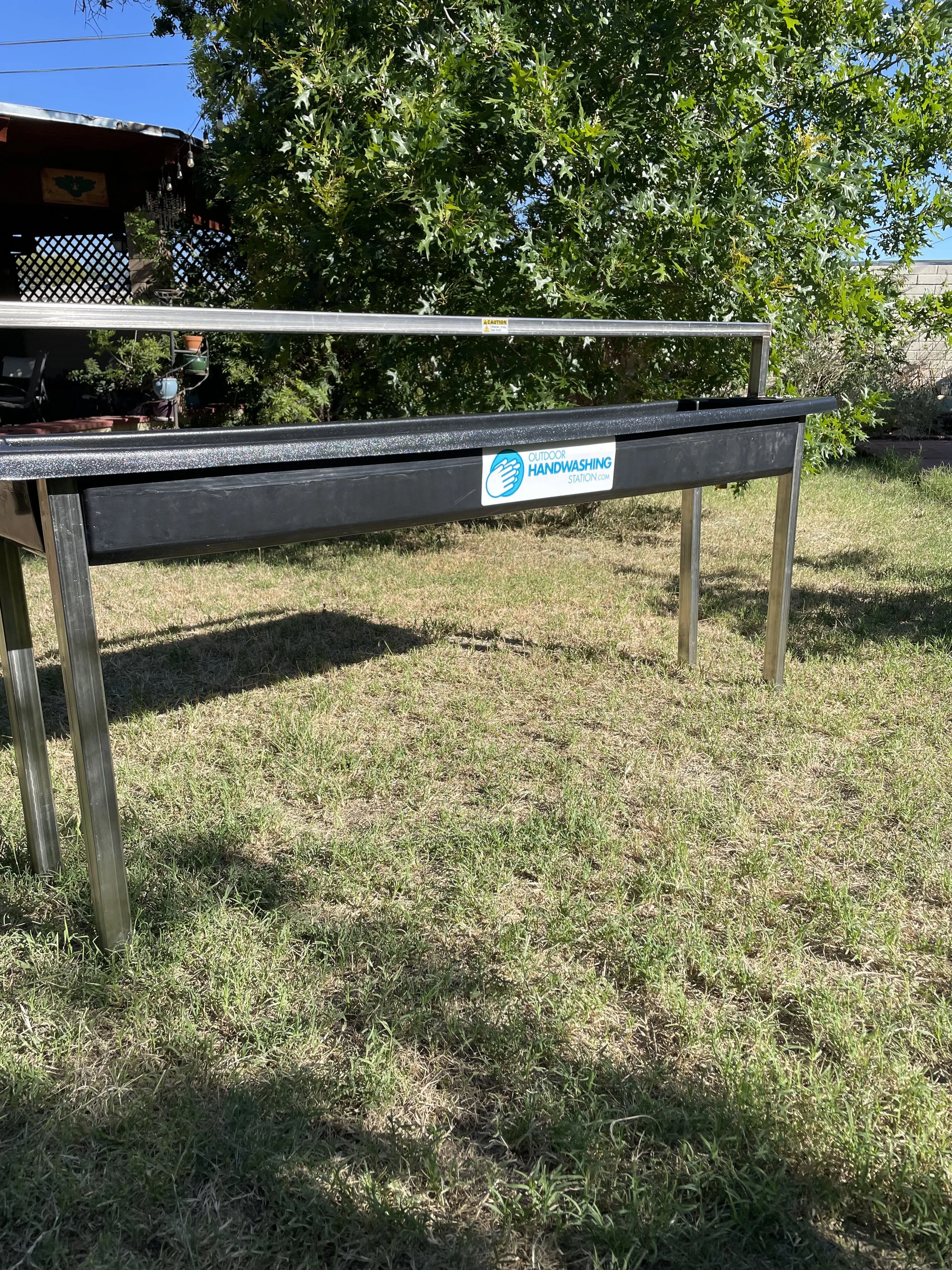 New and improved 6 person outdoor handwashing station set up on a lawn in the Tucson sun.