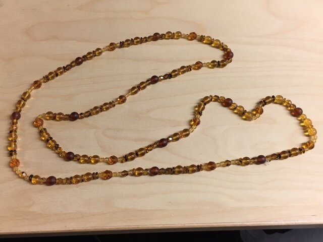 My client had an old strand of amber and brown colored glass beads.  She was going to throw them away, but before she did, she reached out to ask if something could be done with them.