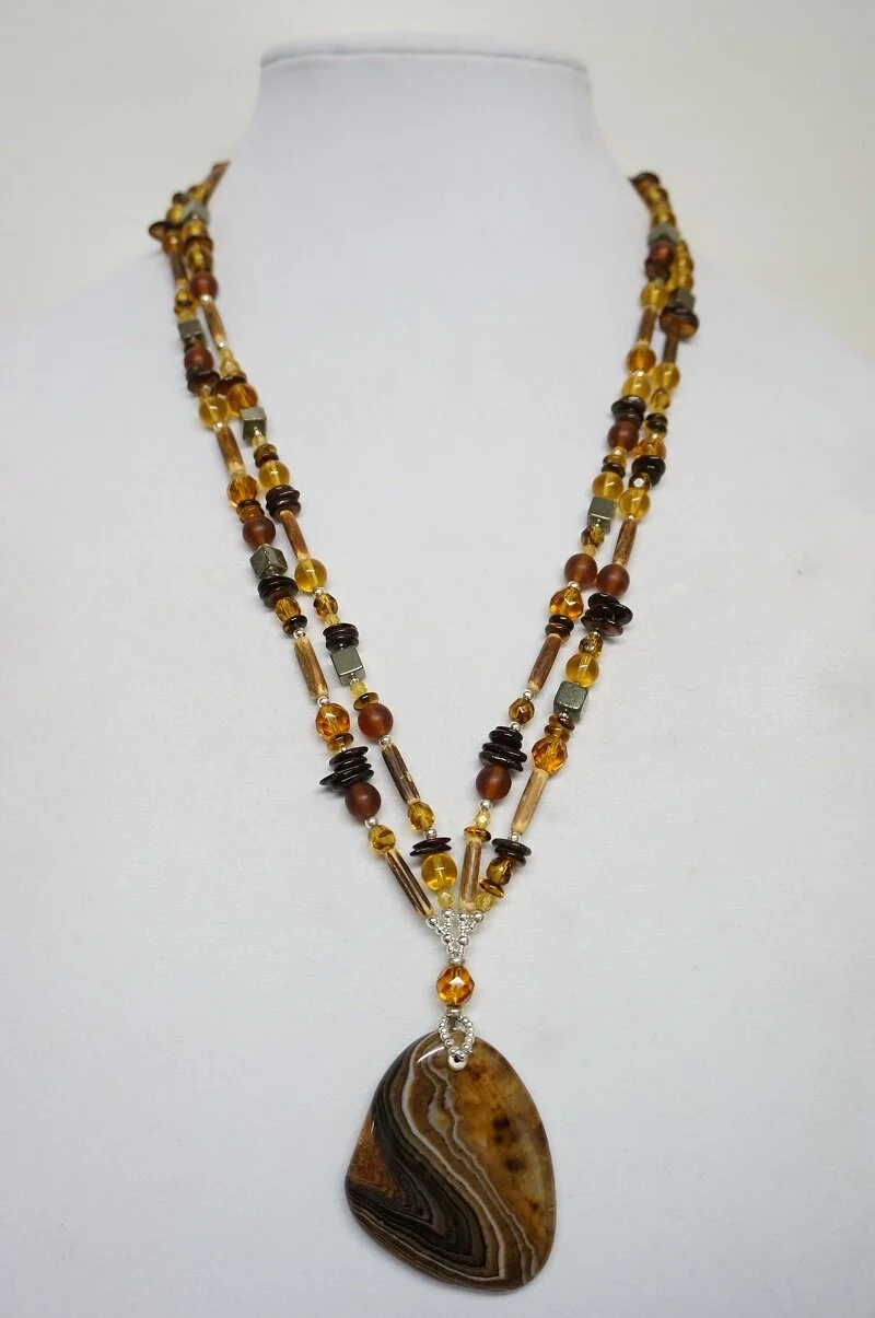 The finished statement necklace.
What was once a single strand necklace, has now become a double strand statement piece with a magnificent pendant!
I incorporated a beautiful agate pendant- that was complementary in shape, esthetic, and color.  I use