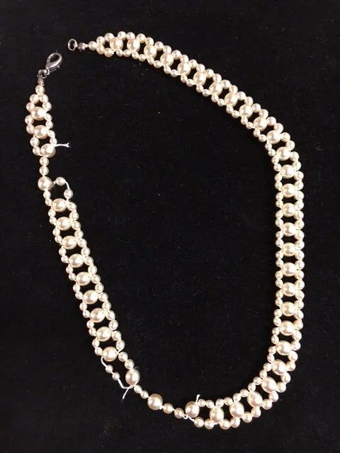 A client had this simulated pearl necklace that had sentimental value to her as her mother gave it to her long ago when she lived in Germany.  It was irreparable and we discussed options.
I explained that I would most likely be able to make 2 pieces 