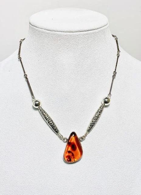I removed the 2 side parts of the original 3 focal piece necklace, incorporated ornate pewter beads combined with 10mm sterling silver beads on either side of the main focal stone.