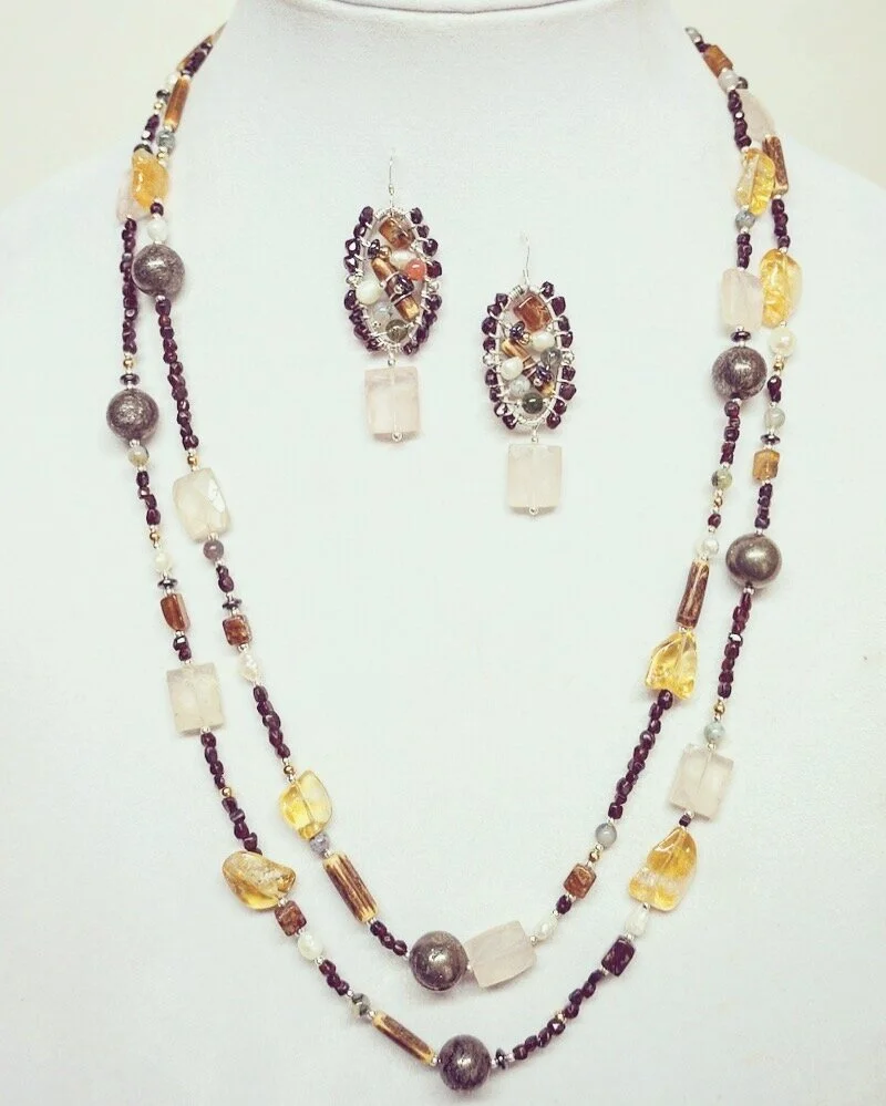 A strand of garnet beads became this amazing set!
The new double strand necklace contains the original garnet, but it now joined with citrine, wood, rose quartz, pyrite, amber, freshwater pearls, and sterling silver.
Very Bohemian. 