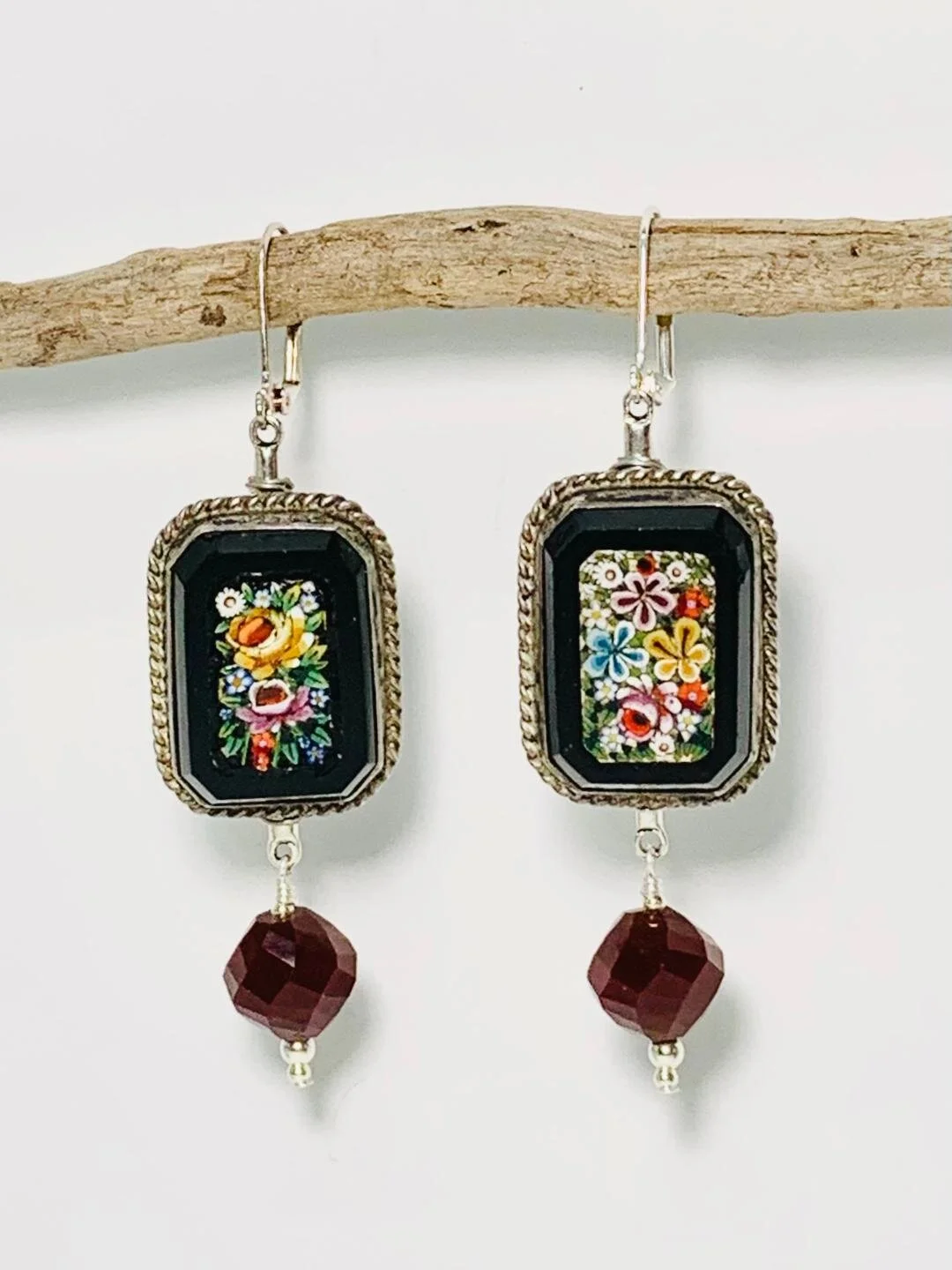 First, these needed to be cleaned thoroughly.  Then I sawed off the cufflink component and sanded the metal until it was soft and fine.  I then wire wrapped the back and incorporated various beads and findings that made them earrings.
I wasn't sure w