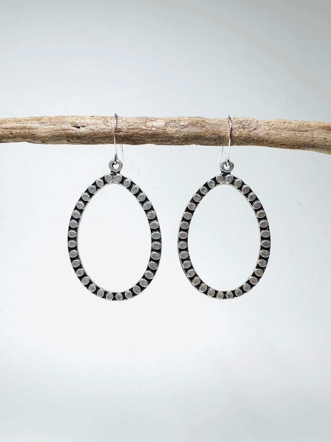 hammered circle flat teardrop hoops front.jpg
