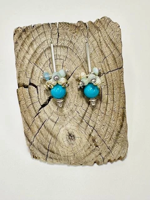 After:  My client requested I design a pair of earrings for her new daughter in law using some of the original blue beads from her necklace.  I used aquamarine, freshwater pearls, varying sterling silver beads, sterling silver ear wires.  