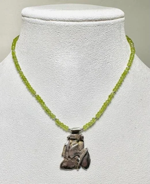 After:  I suggested to my client varying strands of semi-precious stones that she could choose from.  She selected the peridot as she did not have any green colored pieces.  I added sterling silver beads and sterling silver lobster clasp closure.  