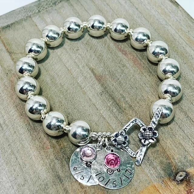 l peyser gma bracelet w new charm on wood.jpg