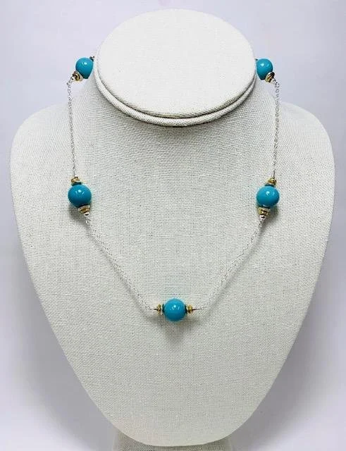 After:  A simple sterling silver cable chain necklace.  Each adorned with 5 of the original blue beads, sterling silver beads, brass discs- so that the necklace could be worn with either silver or yellow gold earrings.  Sterling silver lobster clasp 