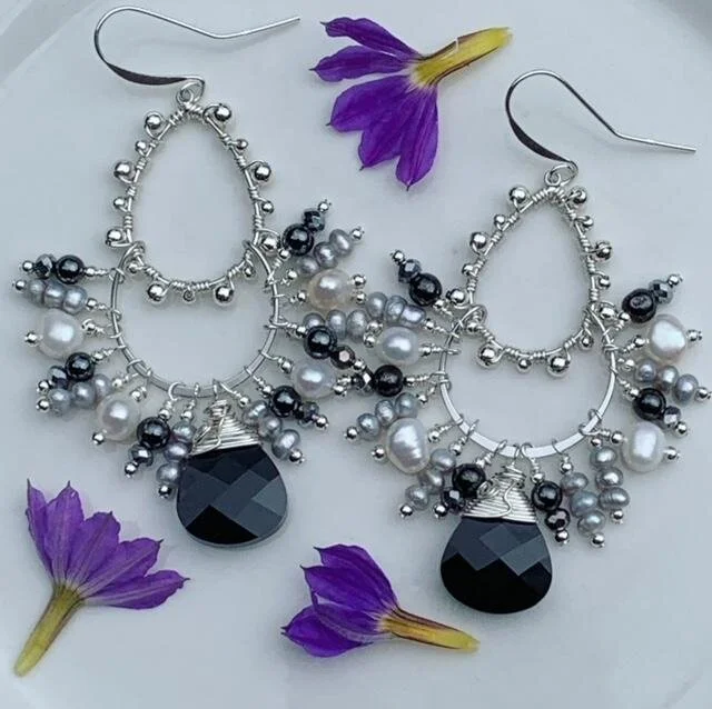 Custom "black and white" bauble earrings.  Faceted black Swarovski crystals are combined with hematite, silver and white freshwater pearls, and sterling silver beads.  These earrings have a fringe look to them, and tons of movement.