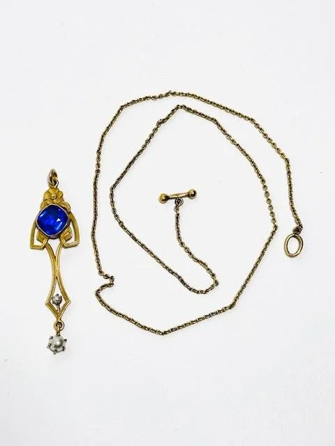 Before:  A brass and blue cut glass pendant with pearl dangle.  Brass chain measuring 13".