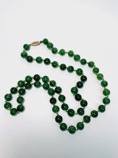 Before- A Great Aunt's strand of knotted jade.