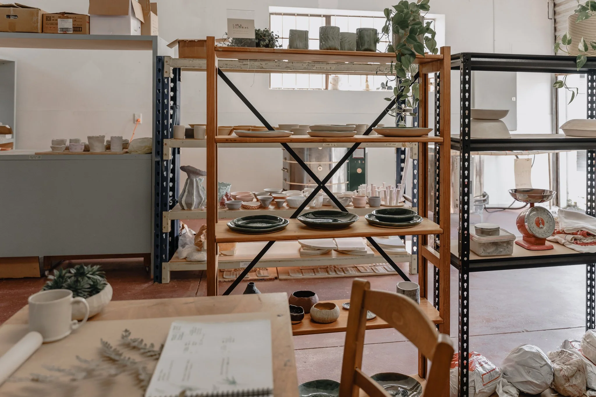 Pottery studio with shelves of ceramics and pottery tools