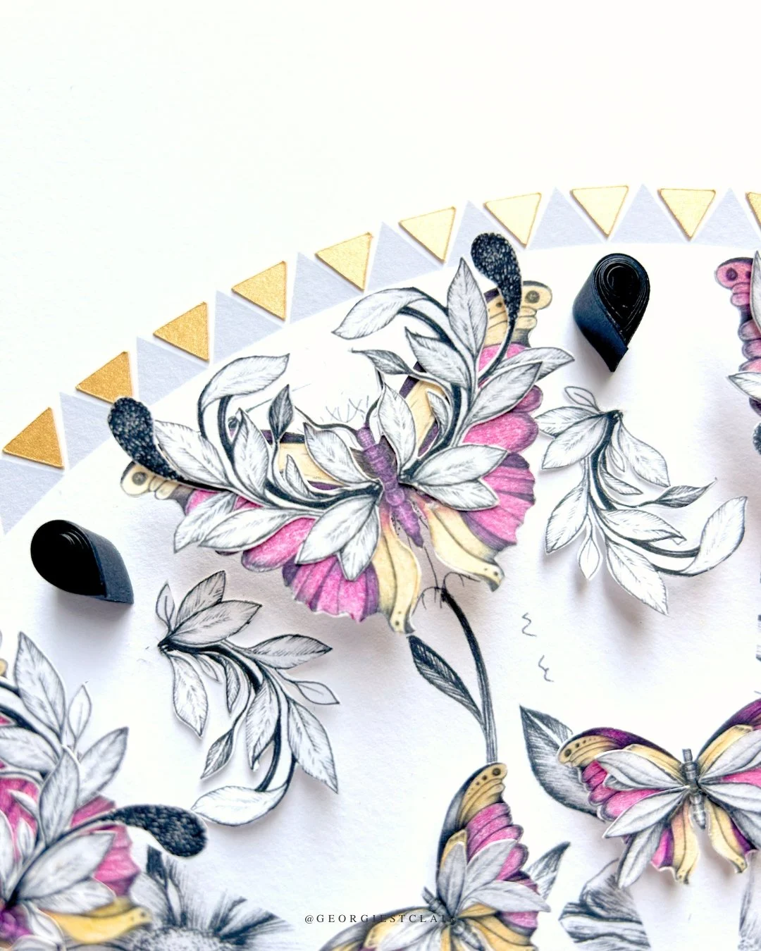 Close-up detail of pink butterfly made from original pen and ink drawings, papercut by hand