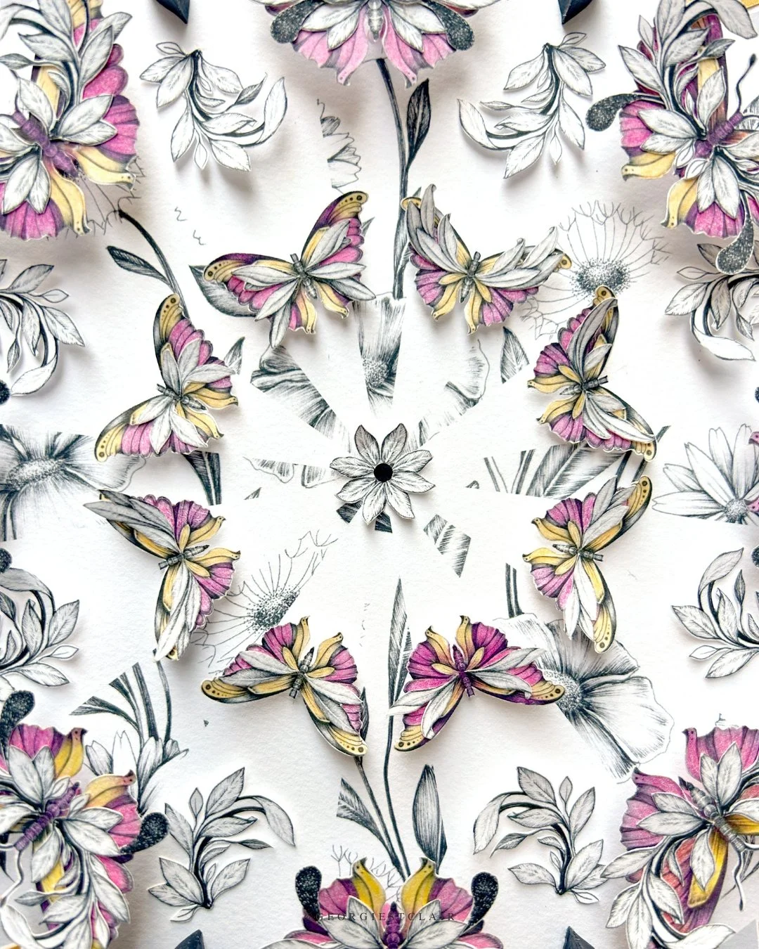 Close-up detail of pink butterfly mandala made from original pen and ink drawings, papercut and quilled paper