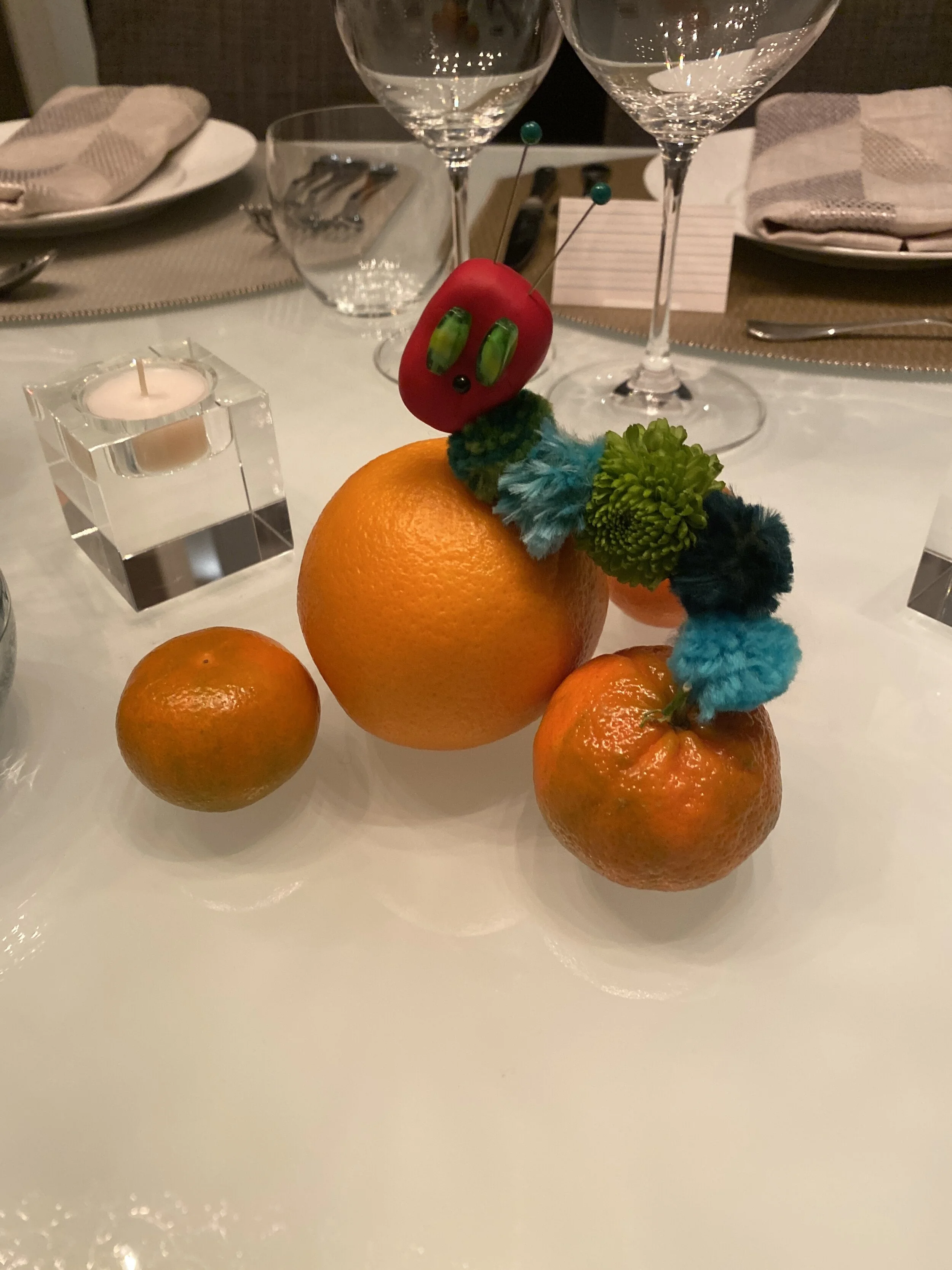 Caterpillars made from clay, wire, beads, pom poms and real flowers.