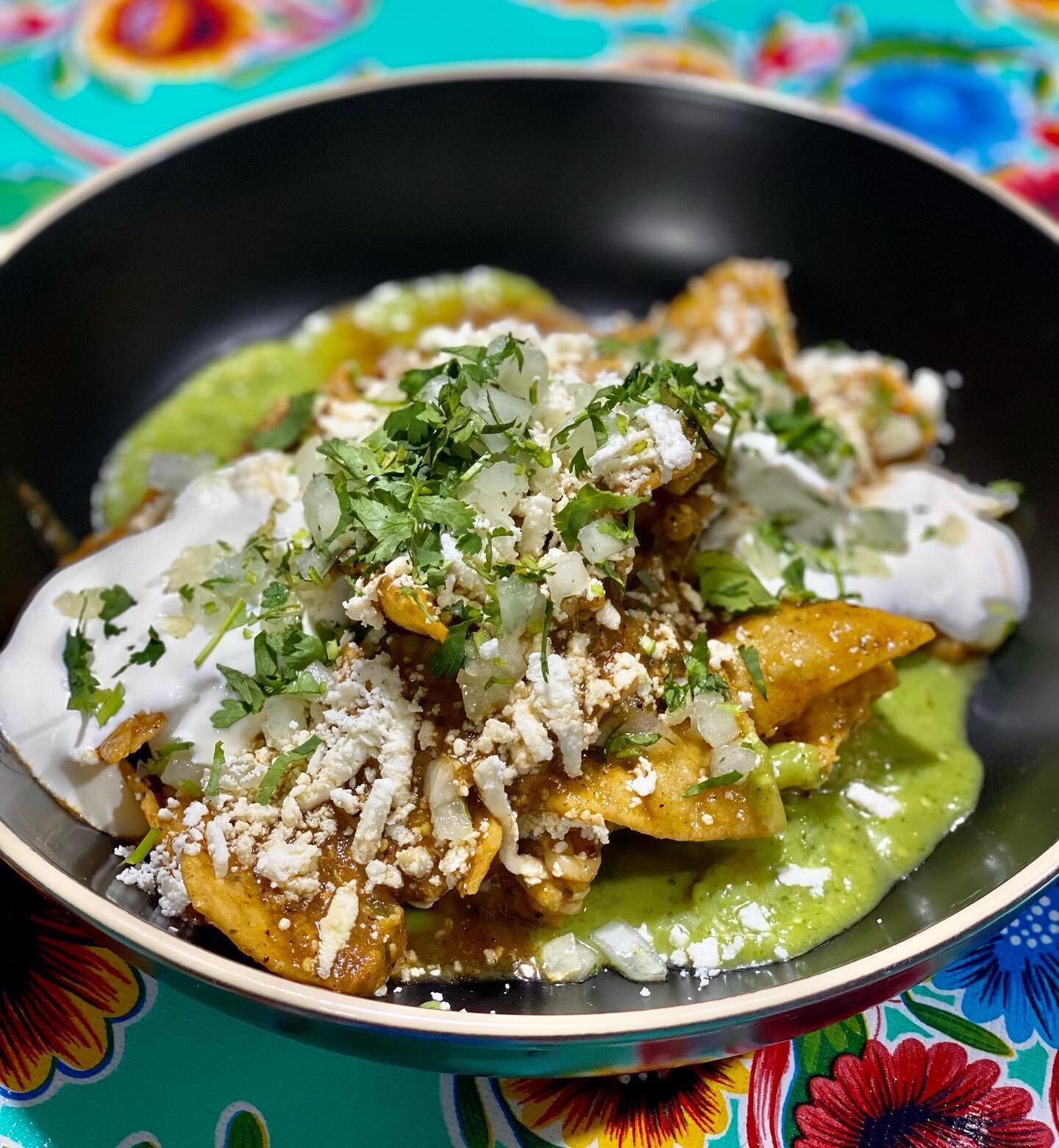 Saturday Special 🧨 Spicy Chilaquiles : White corn tortillas tossed in a spicy guajillo tomatillo salsa, Jack cheese blend, onion, cilantro, served with sour cream, queso fresco, &amp; avocado tomatillo salsa ! Then load it up with all the fixings yo