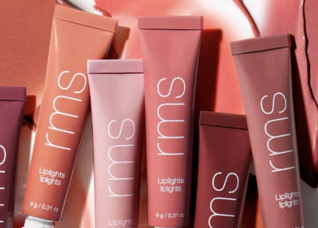 colored cream lip gloss bottles against a white backdrop