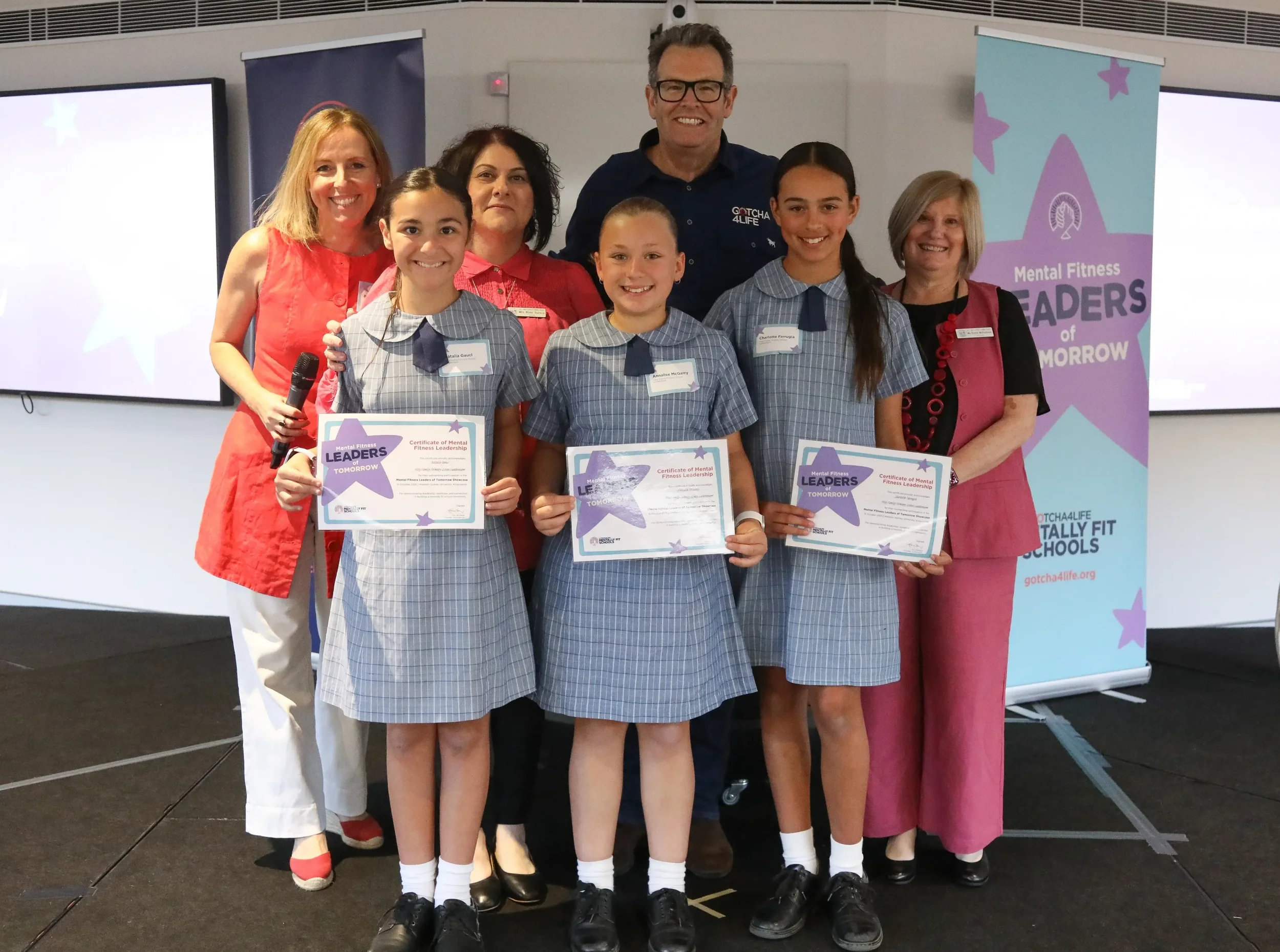 Gus, Gotcha4Life Founder, and Bel, Gotcha4Life CEO with a teacher and students from Holy Family Luddenham school at Gotcha4Life's Mental Fitness Leaders of Tomorrow event.