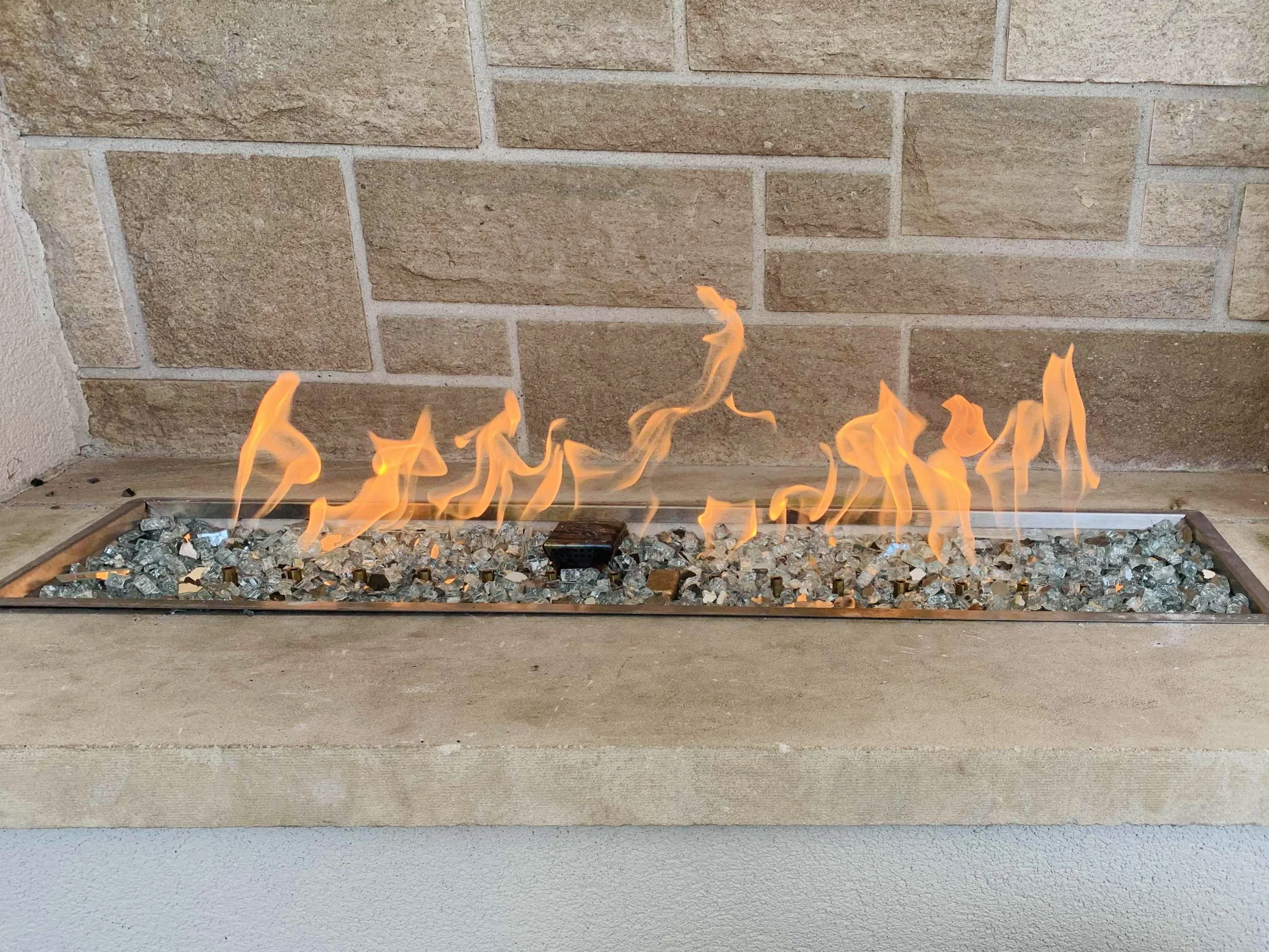 Custom indoor gas fireplace designed and installed by DHS Systems, integrated into a modern residential interior.