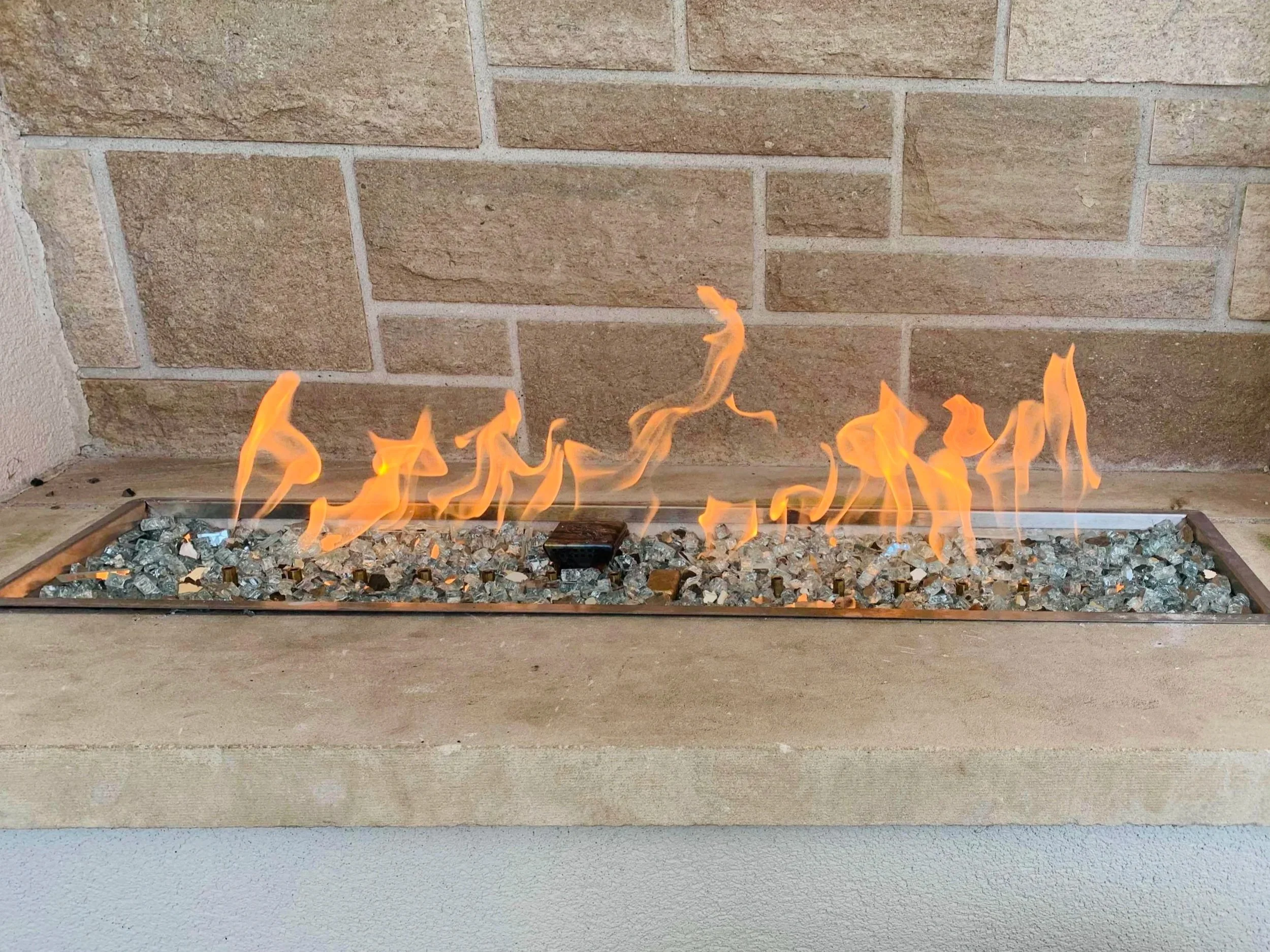 Custom indoor gas fireplace designed and installed by DHS Systems, integrated into a modern residential interior.