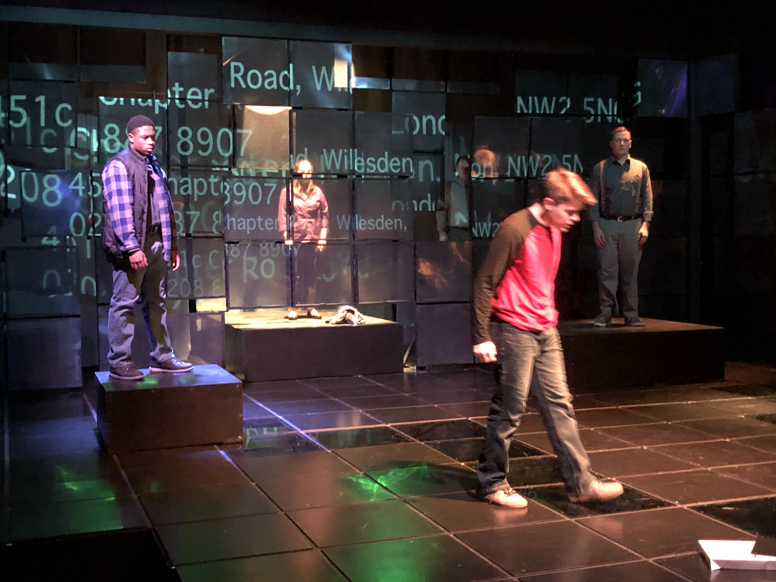 Prod photo: Christopher recites his Mother's address.  He thought she was dead.  The walls and light effect allows the actors to bleed through the set and projections As if we're seeing inside his mind.