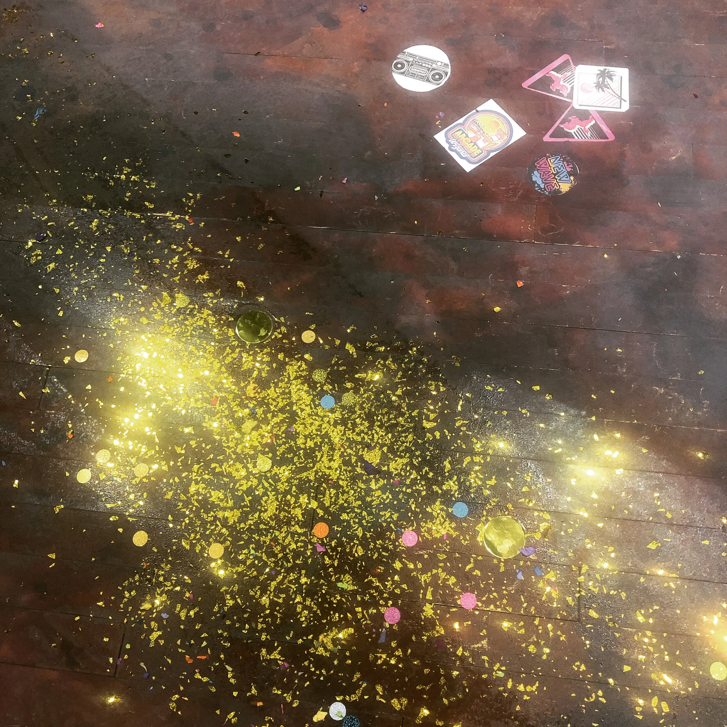 Glitter painted into the floor.  I wanted the place to look like it would have on a Monday morning.  Glitter, stickers and club fliers were painted into the floor.