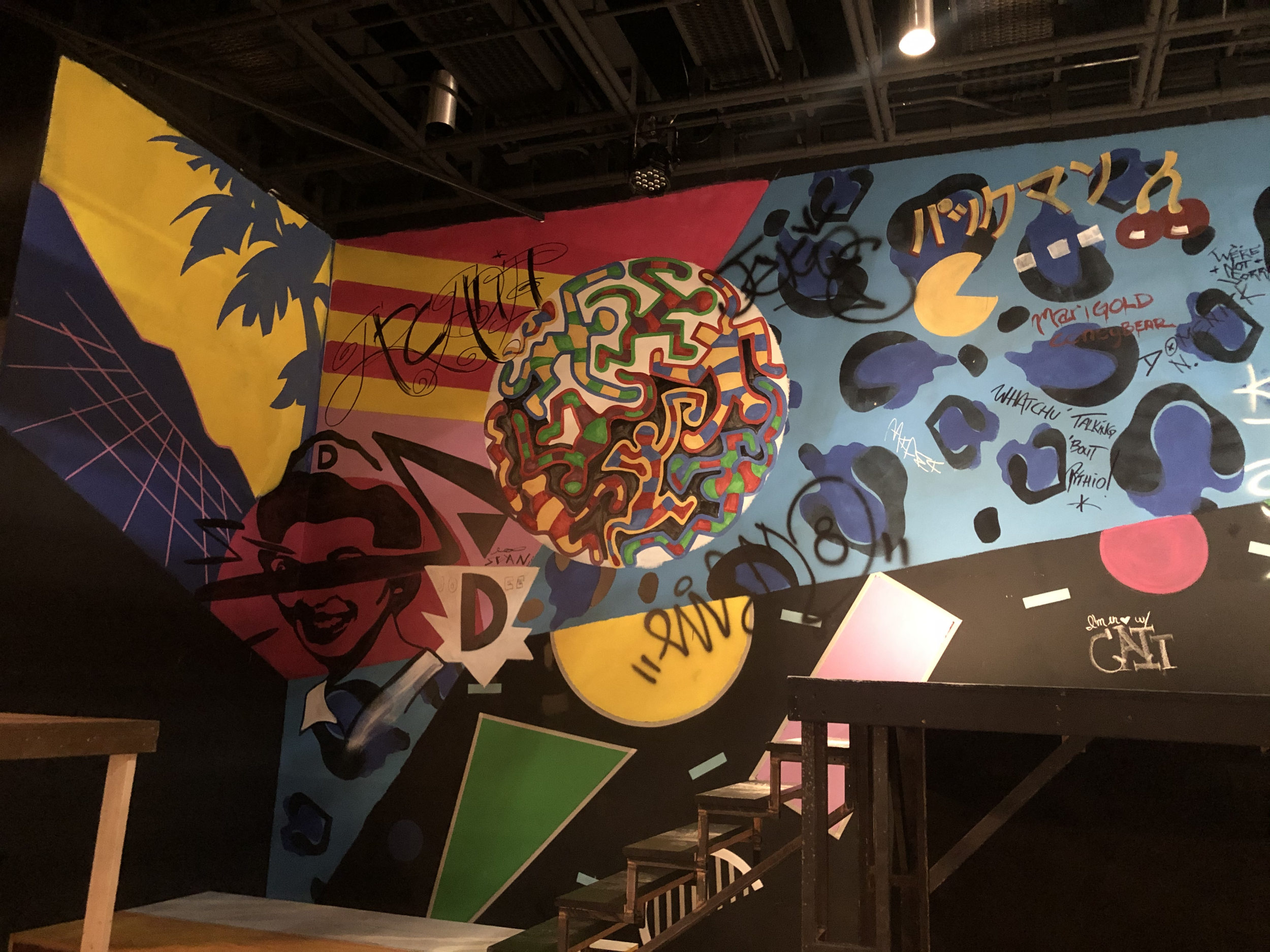 Graffiti wall featuring 80's graphic design and Keith Herring art.  I also let the cast come in and tag their names and add to the graffiti layers.  I like to utilize the cast in my design work where applicable.