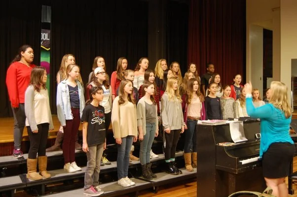 Research of students singing on risers.