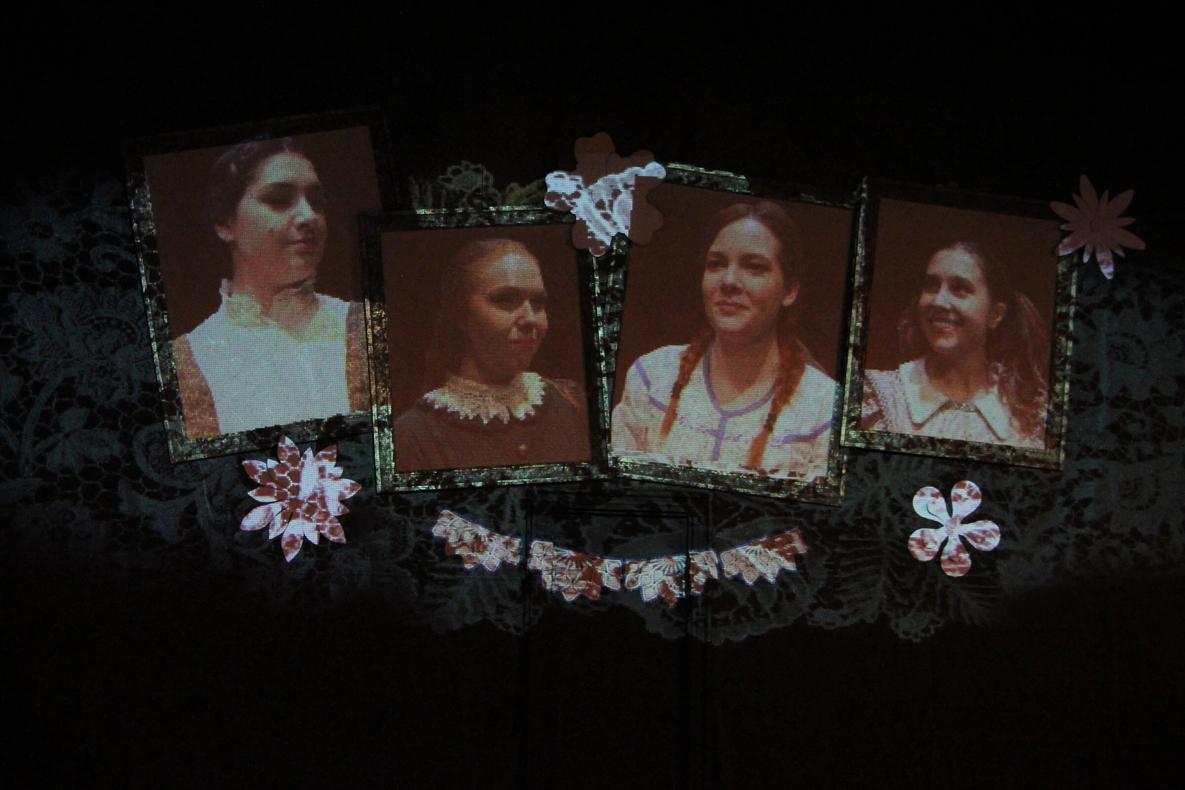 I projected the "Little Women" onto the main curtain.  I like to use the actors in my designs when possible.