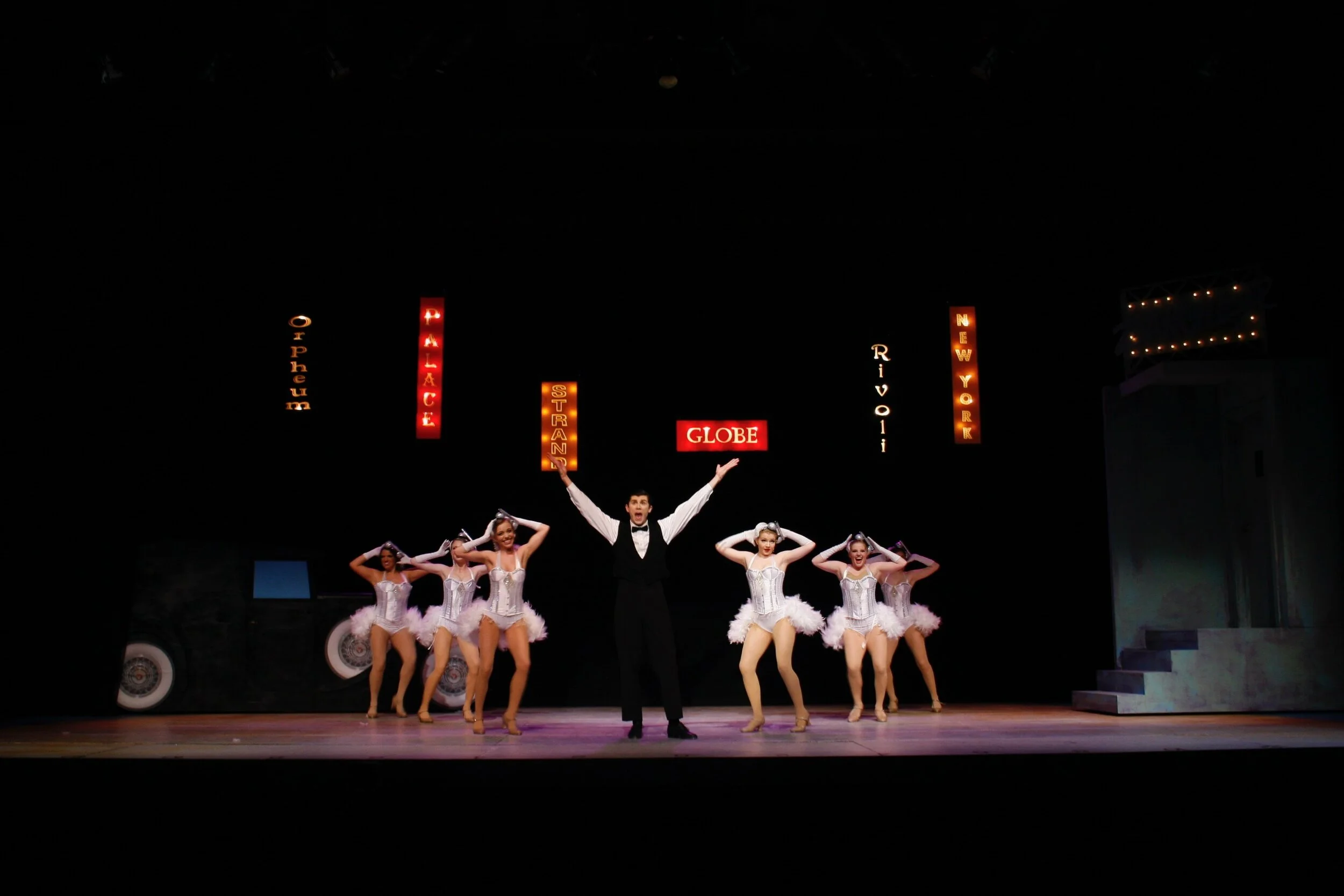 Prod. photo: NYC- we built a 2d limousine where the dancers came up through a trap in the floor and came onstage as if coming through the car's hood.