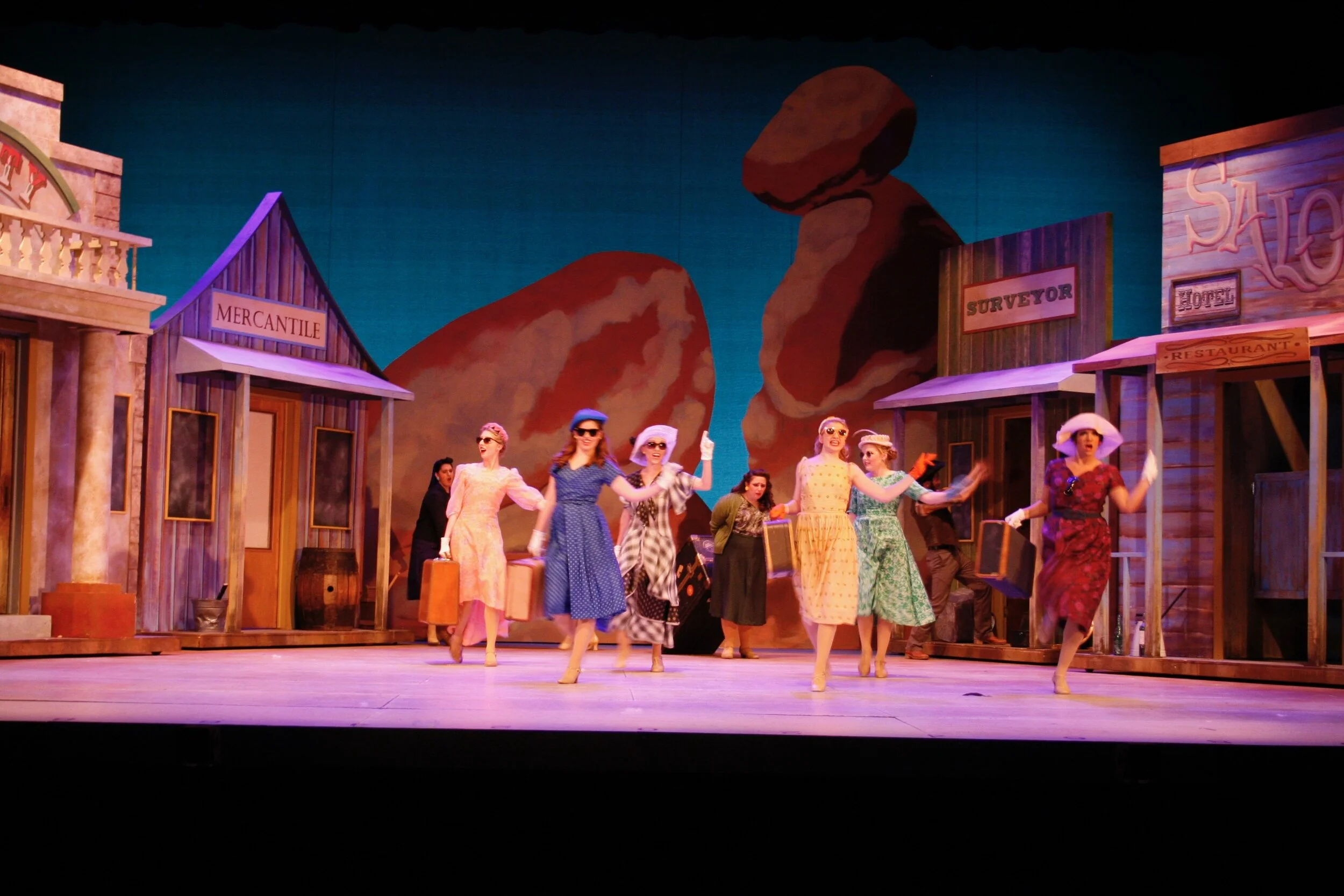 Musical number- NYC cast arriving in the small town
