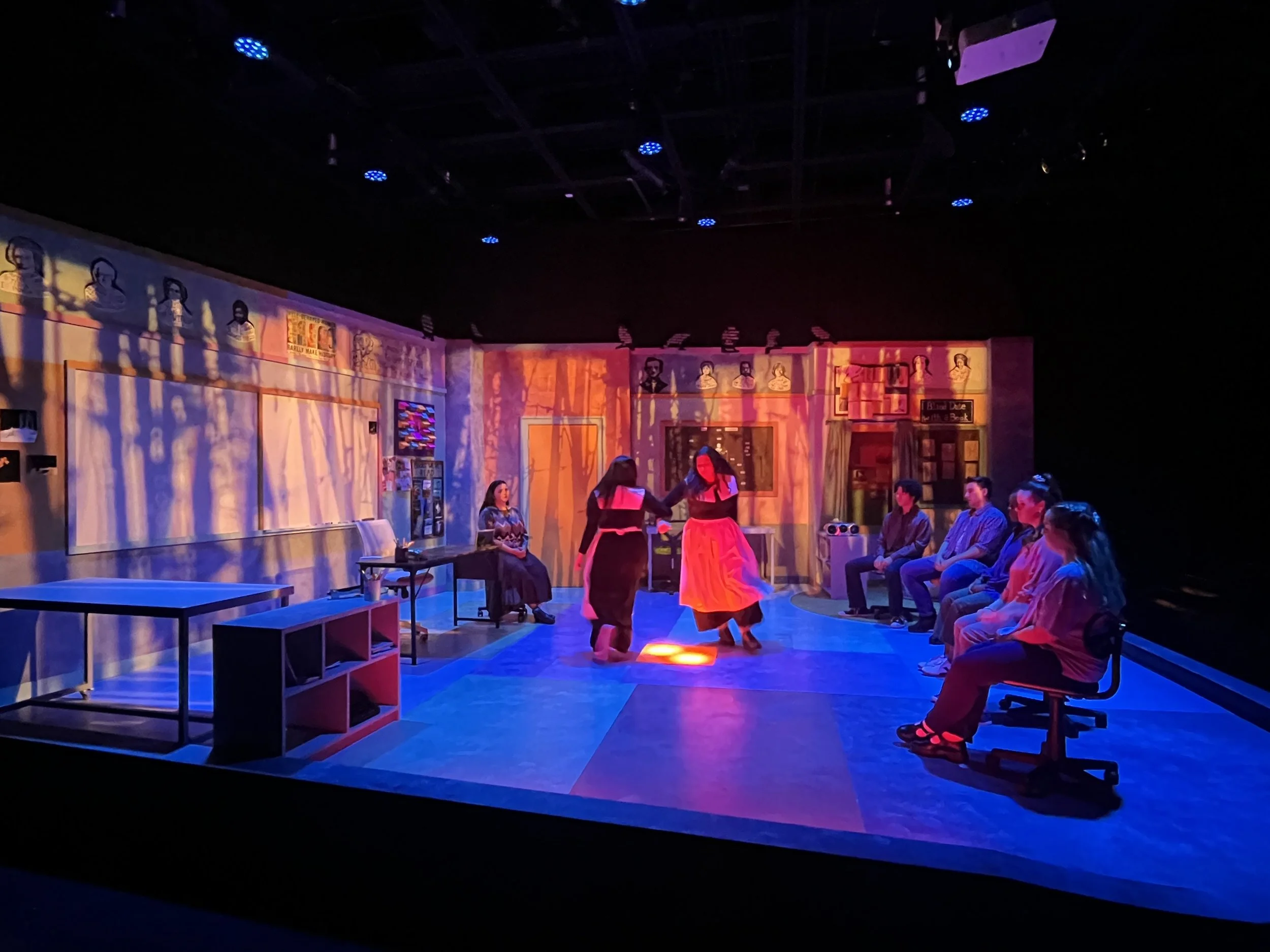 The students break out into a rage filled dance like the girls in The Crucible- Projections transformed the space into woods and eventually flames