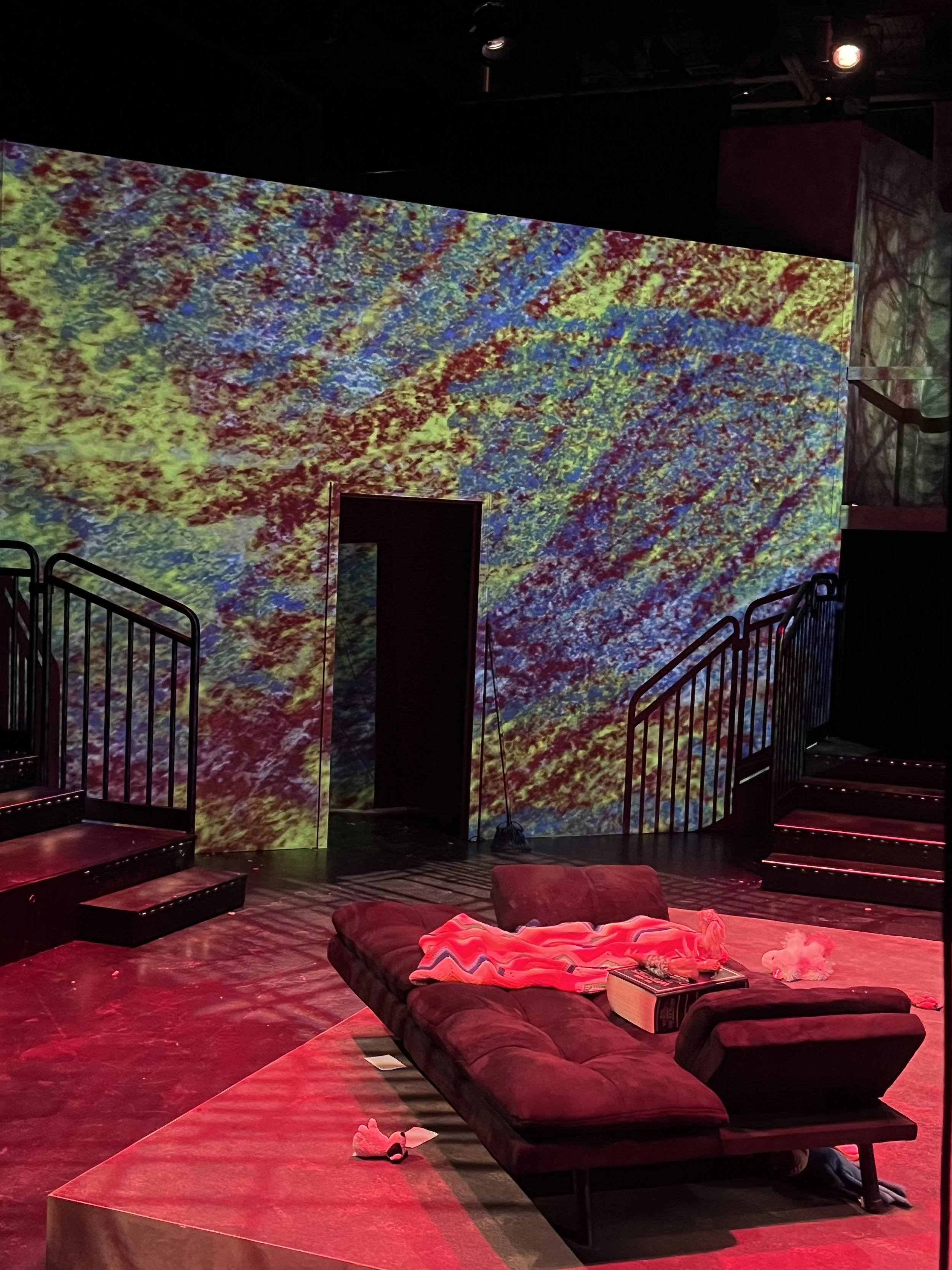 Projections were used on all four walls and on the floor to suggest a TV set