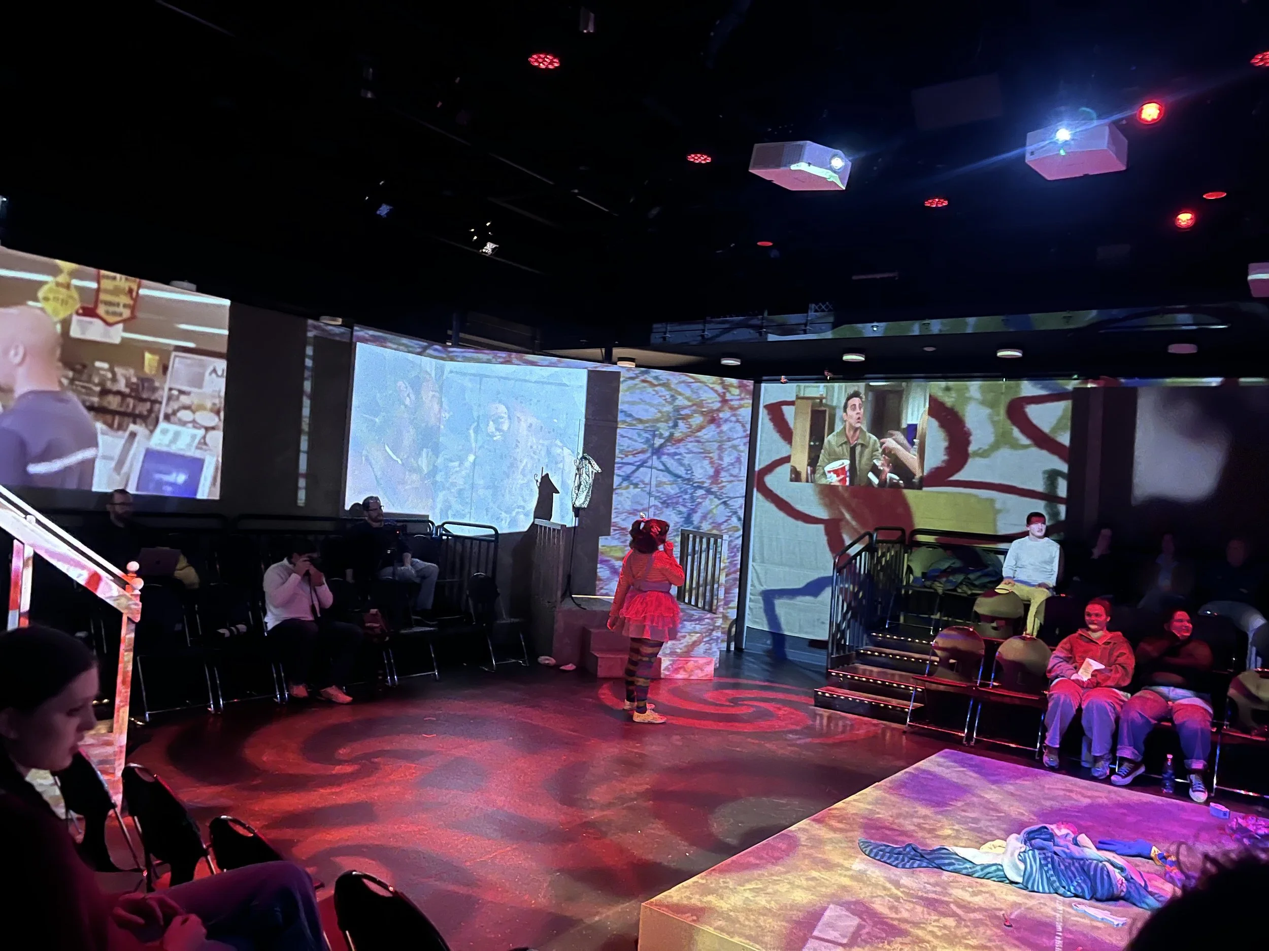 90's TV commercials, like Jered rom Subway, were projected around the room to add to the chaos of the scene