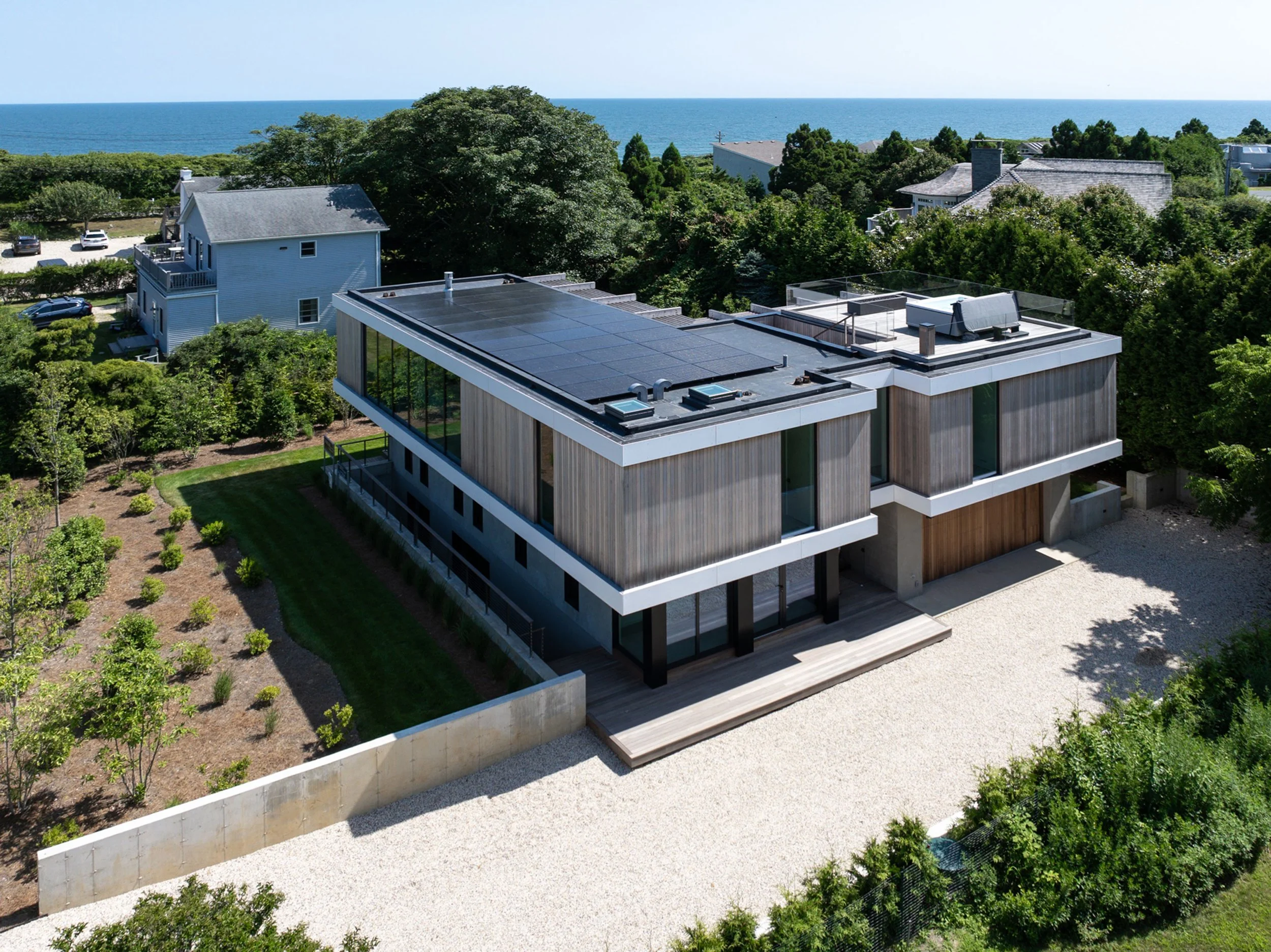bda_jackson-rd-residence_drone-mahogany-siding-fiber-cement-siding-ocean-view-roof-deck.jpg
