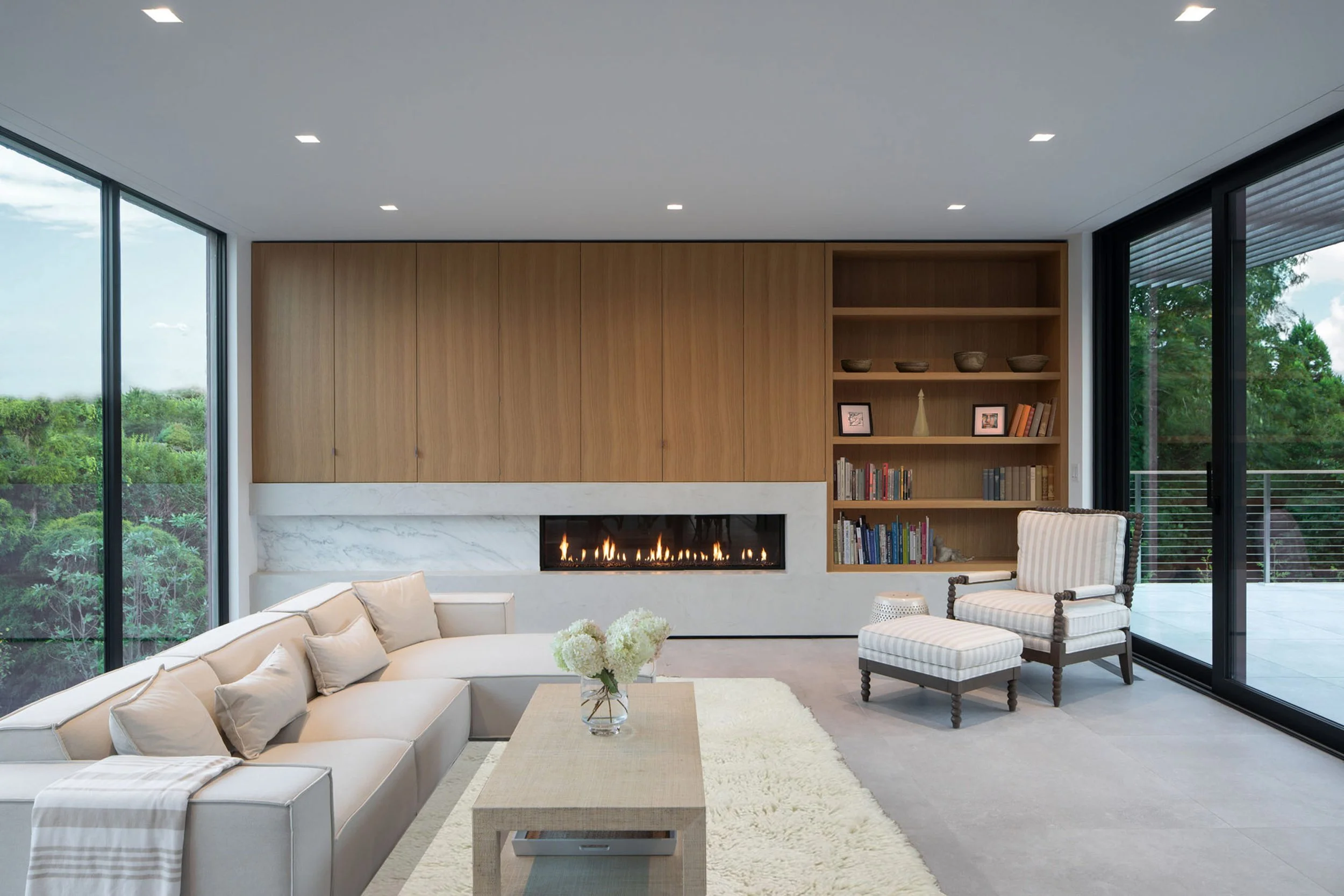 bda_jackson-rd-residence_modern-fireplace-white-oak-concrete-floor-sliding-glass-door.jpg