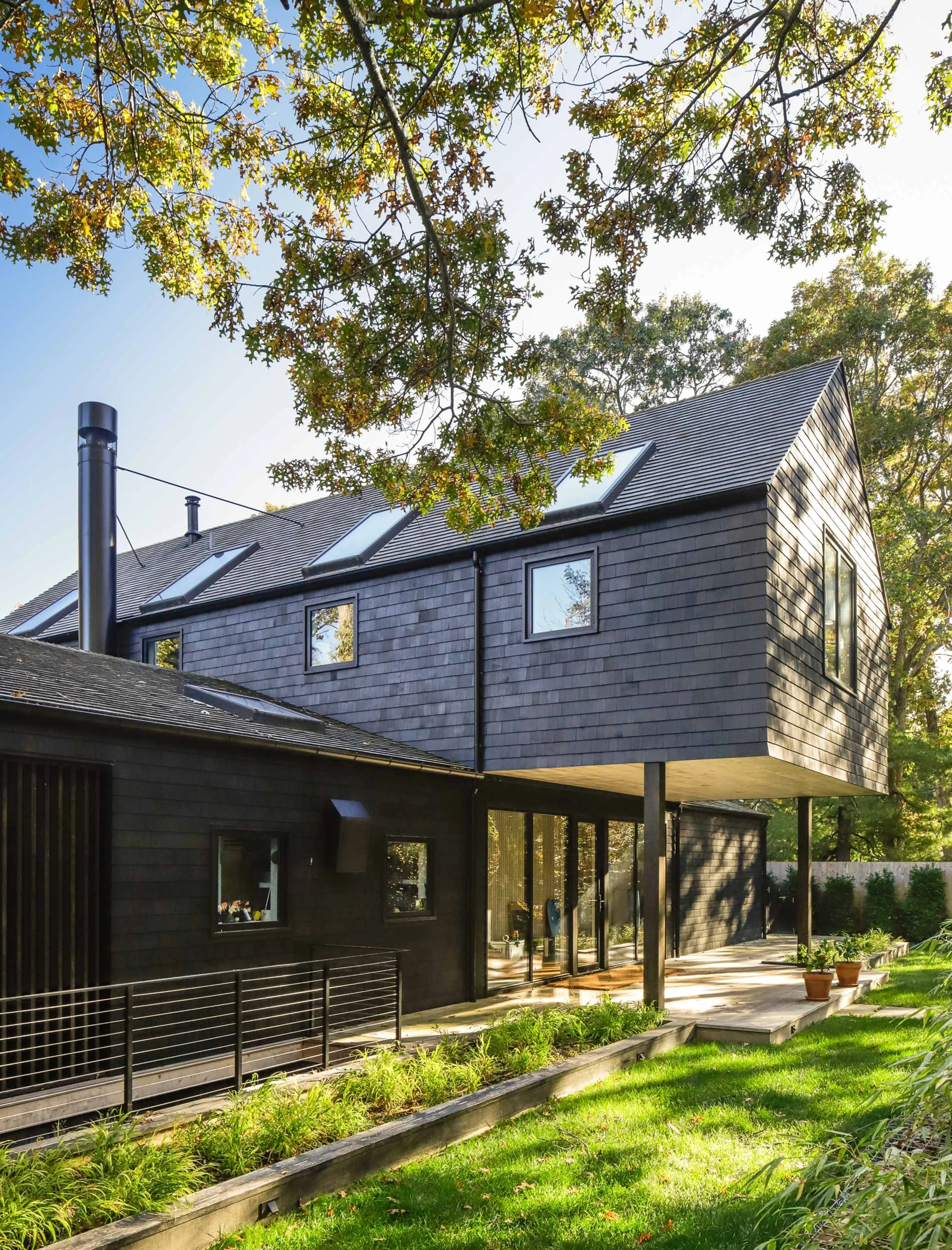 Barn-inspired modern home with cross-shaped second floor in East Hampton