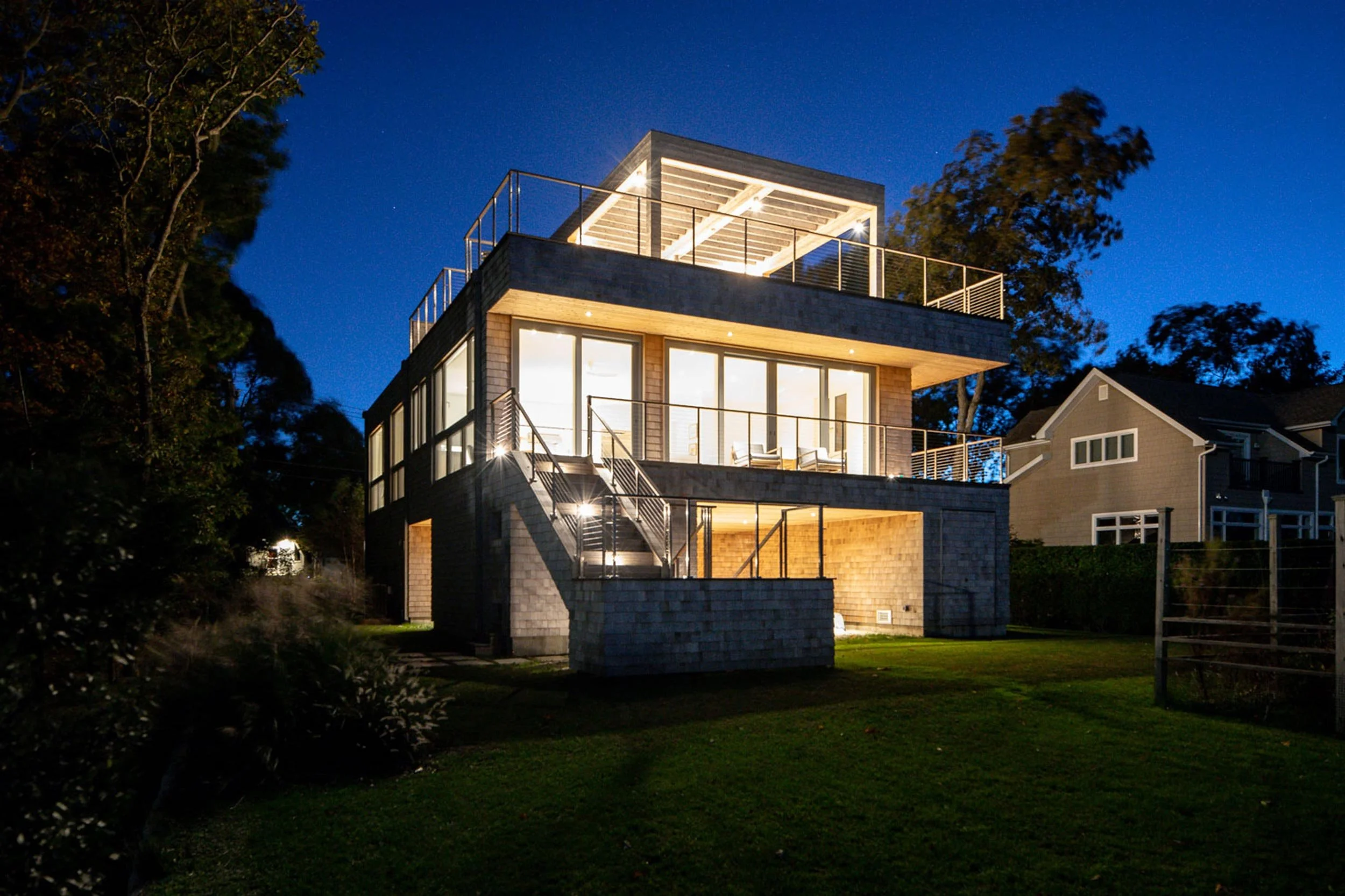 Elevated coastal home with cedar shingles and solar panels, Greenport North Fork