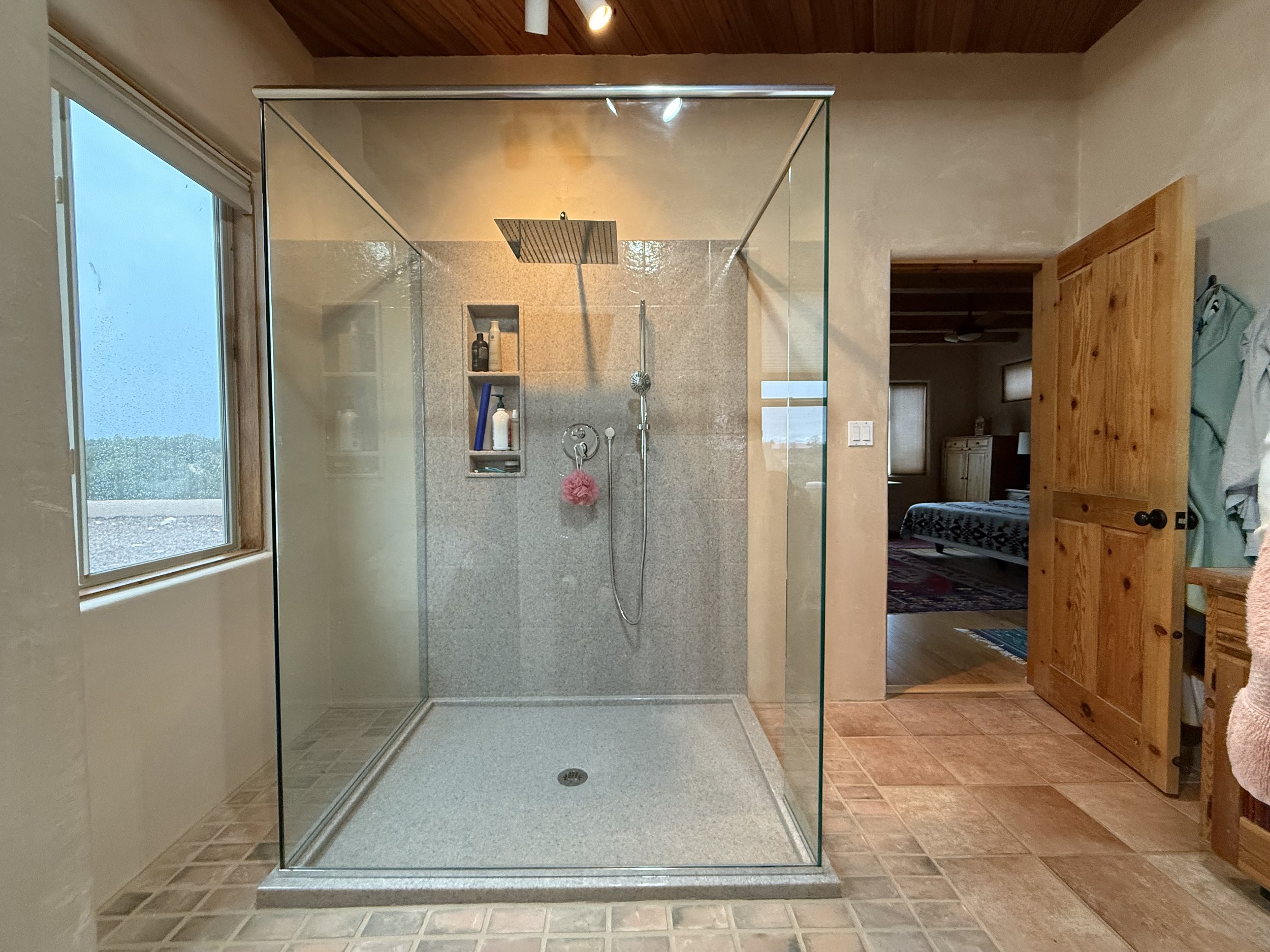 Spa tub replaced with custom Onyx Collection Shower with tower caddy and new fixtures.