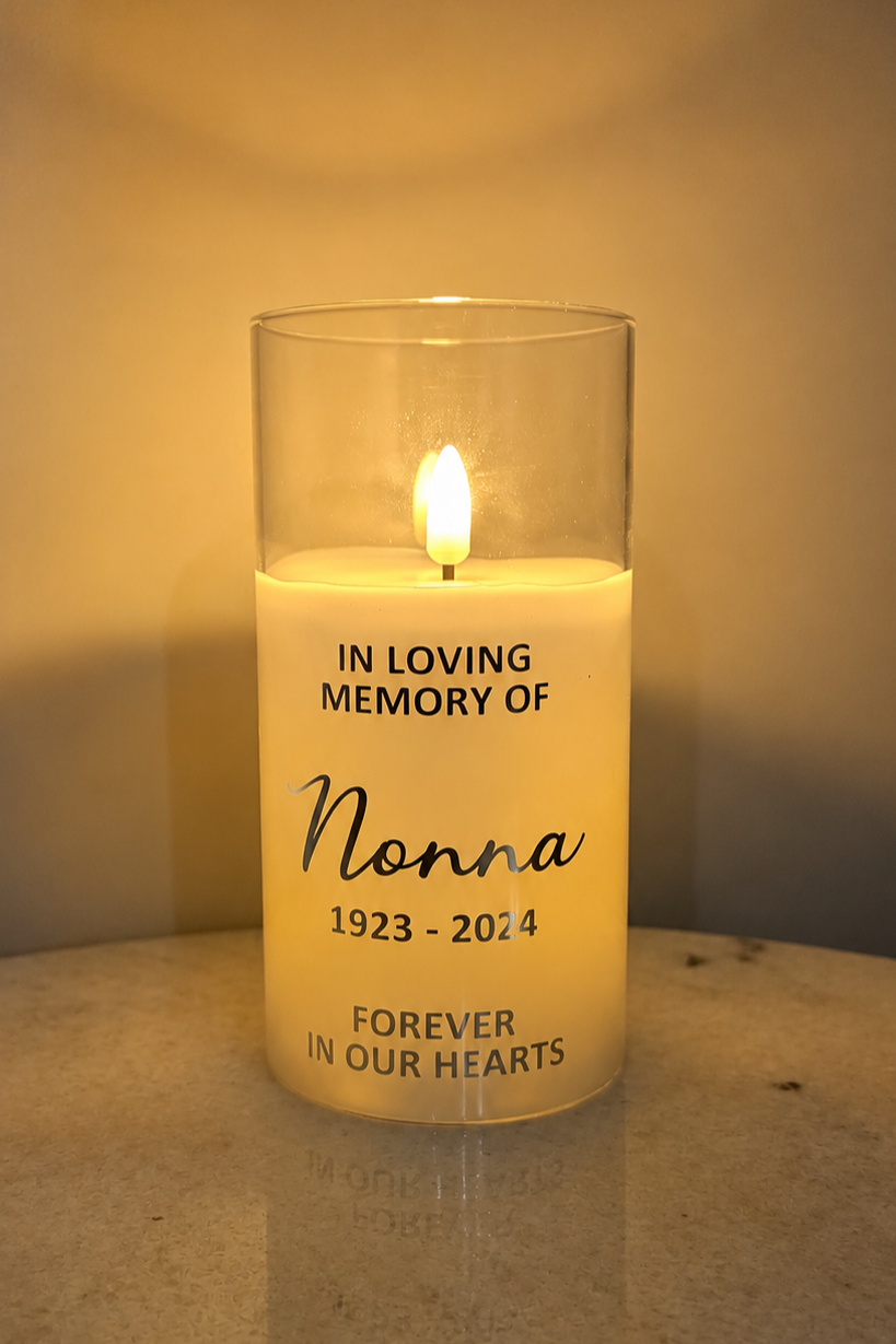 Front view of an illuminated LED memorial candle with “In loving memory of Nonna”, 1923–2024 and “Forever in our hearts” lettering.