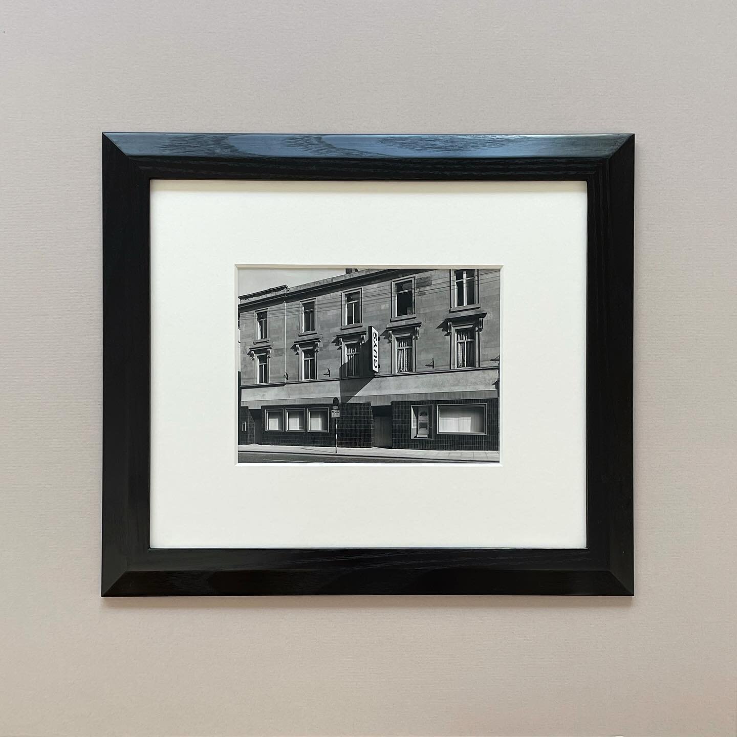 Photograph in ash frame with angled profile, stained black, polished and waxed