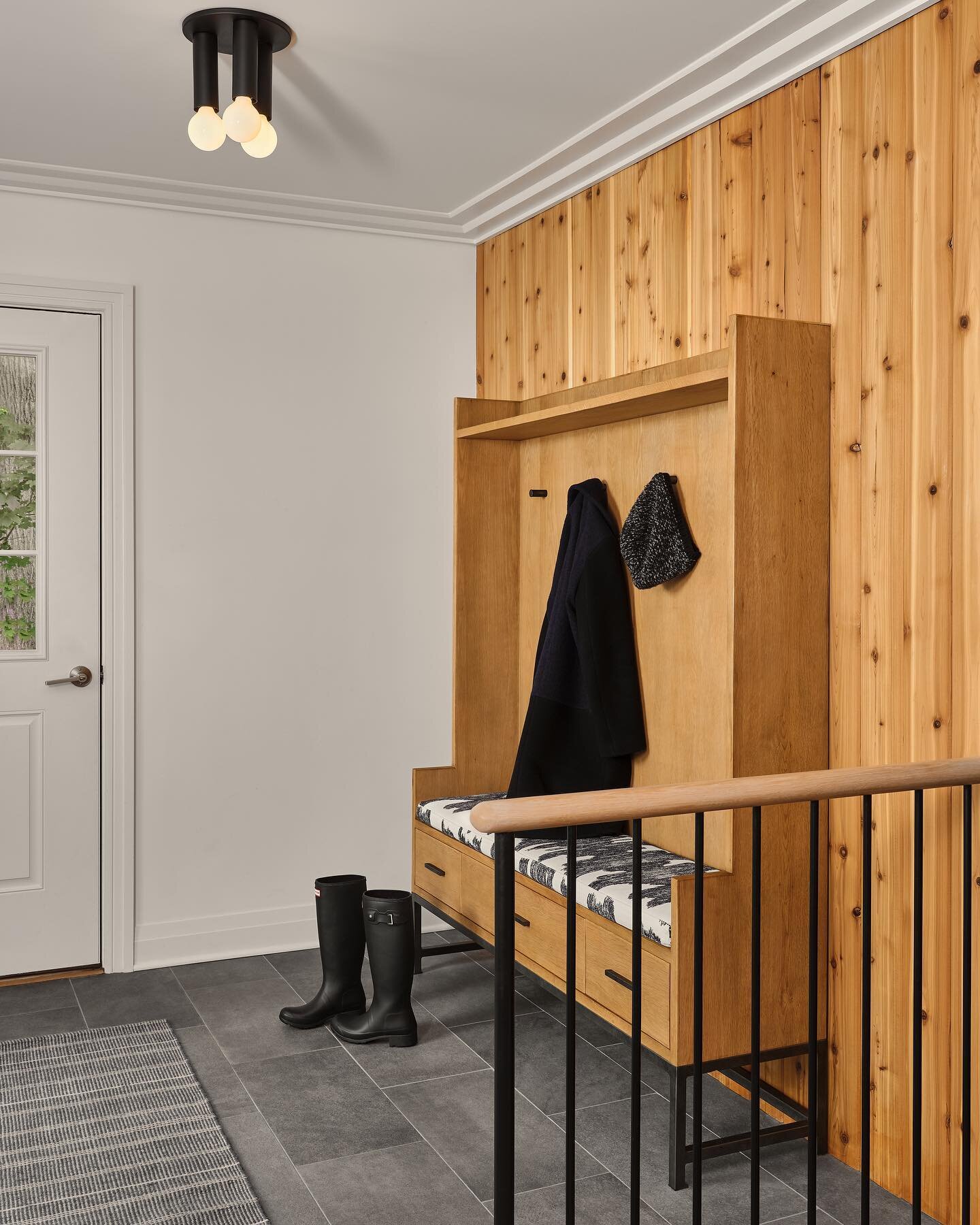 The mudroom of this Scarsdale home is used by the family often, so we added a functional bench with hooks for coats and removing boots as well as durable and washable runners.
Semi-flush lighting was chosen due to the ceiling height. A semi-flush mou