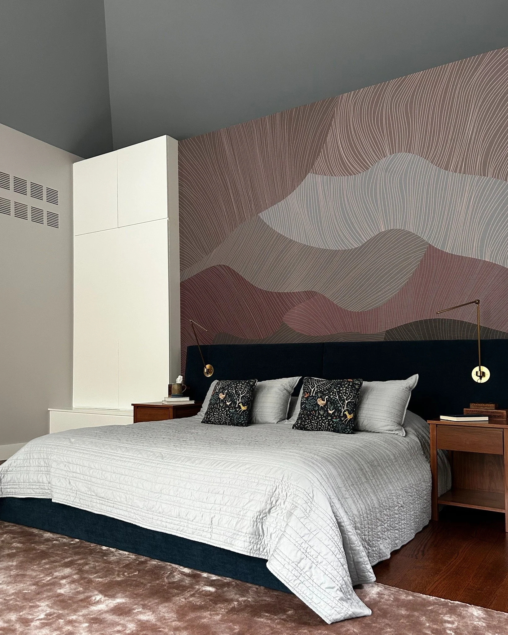 Don't you love a good before-and-after? This one's from our Pawling project.

We added custom 11'-high millwork for extra storage, swapped the old vents for sleek flush vents, and painted the walls and ceiling contrasting colors. The headboard wall g