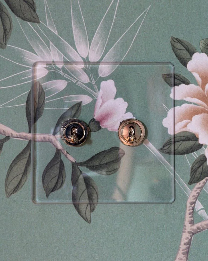 The devil is in the details. This clear switch plate detail seems simple, but, uh oh, we used a non-pattern-repeat wallpaper. Thanks to signsandwondersnyc for cutting the wallpaper to precision and placing it accurately behind the switch plate, it lo