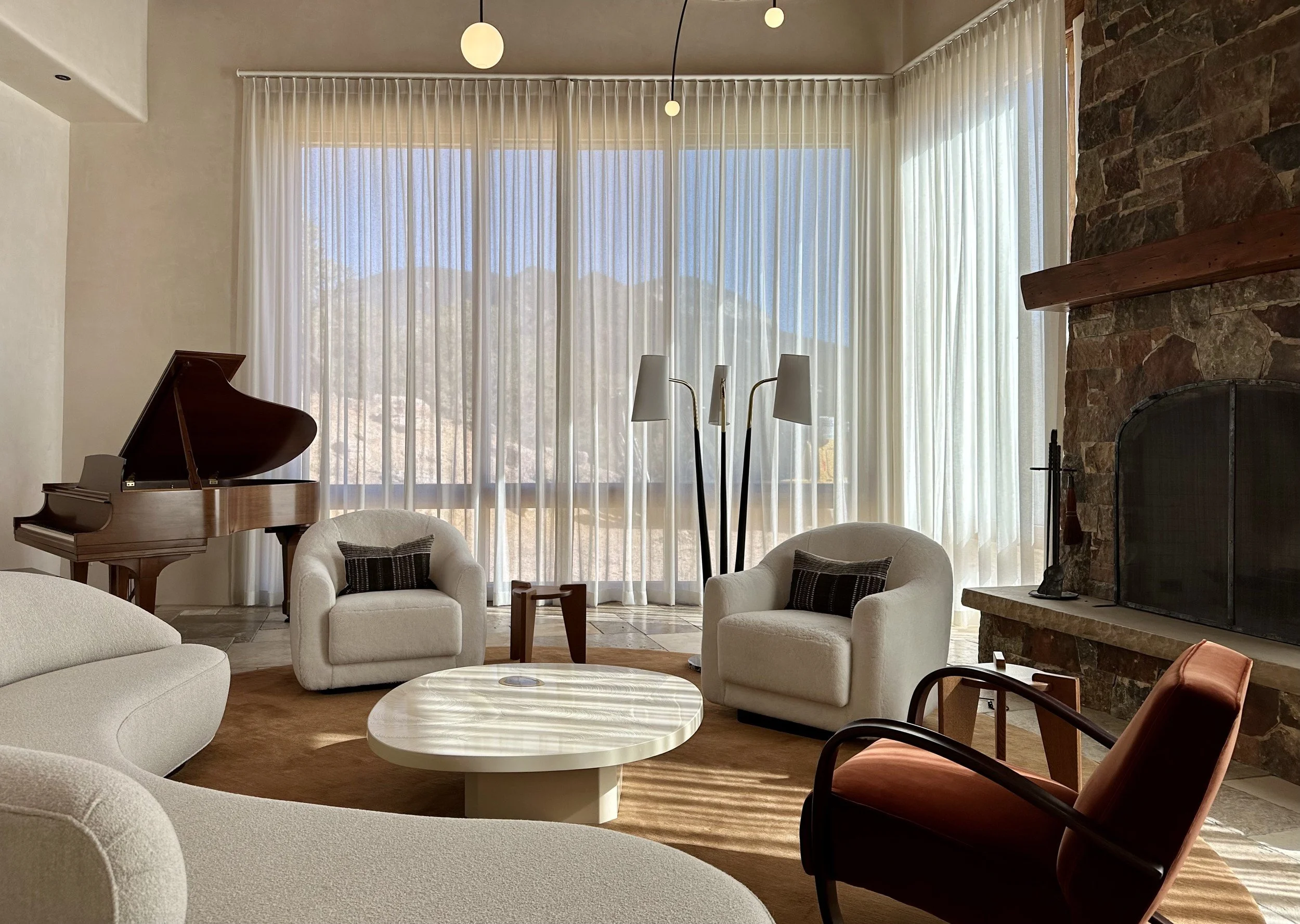 new-mexico-hideaway-01-living-room-piano-stone-fireplace.jpg