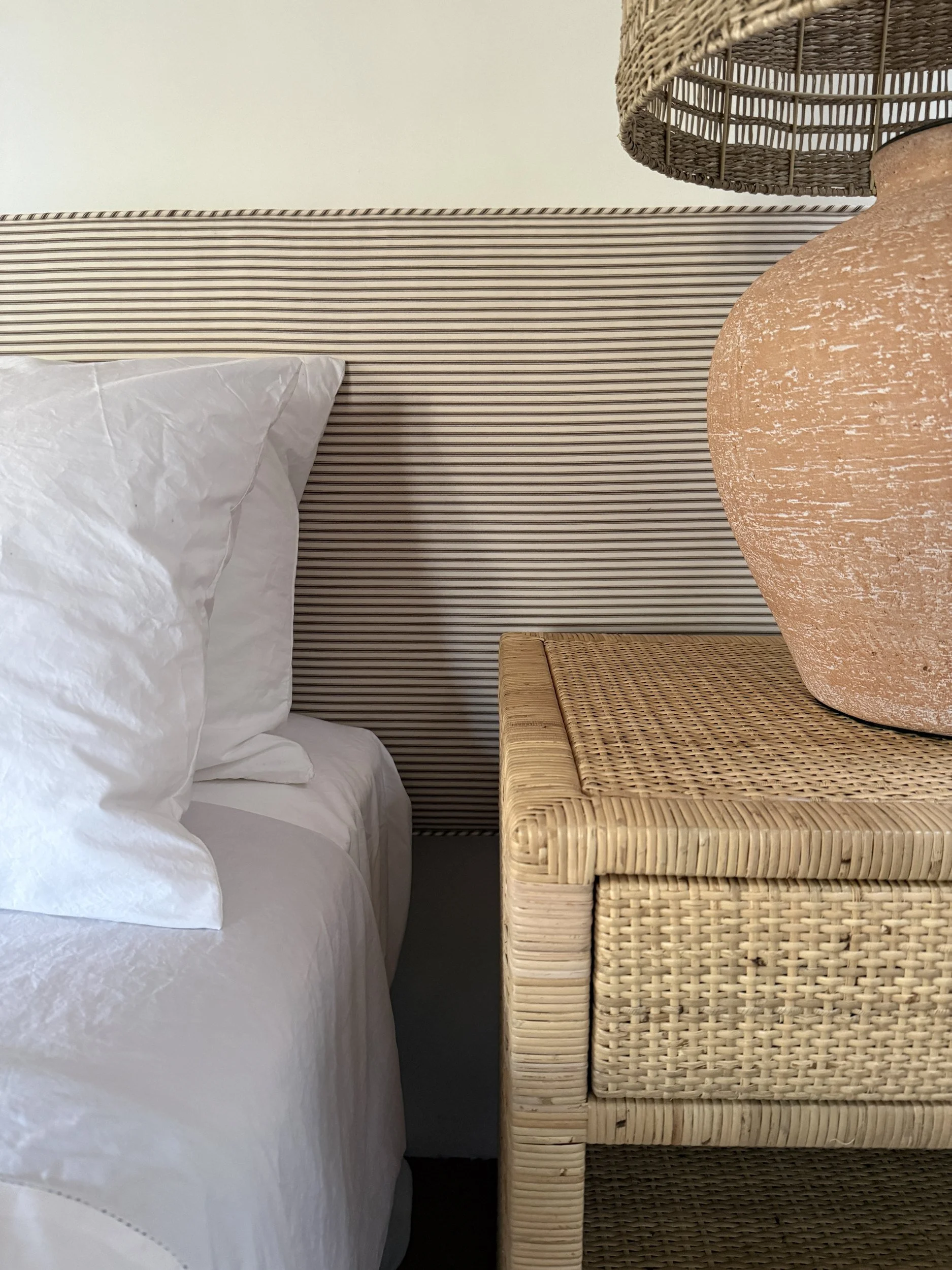 odds-and-ends-06-ticking-stripe-headboard-rattan-nightstand.jpg